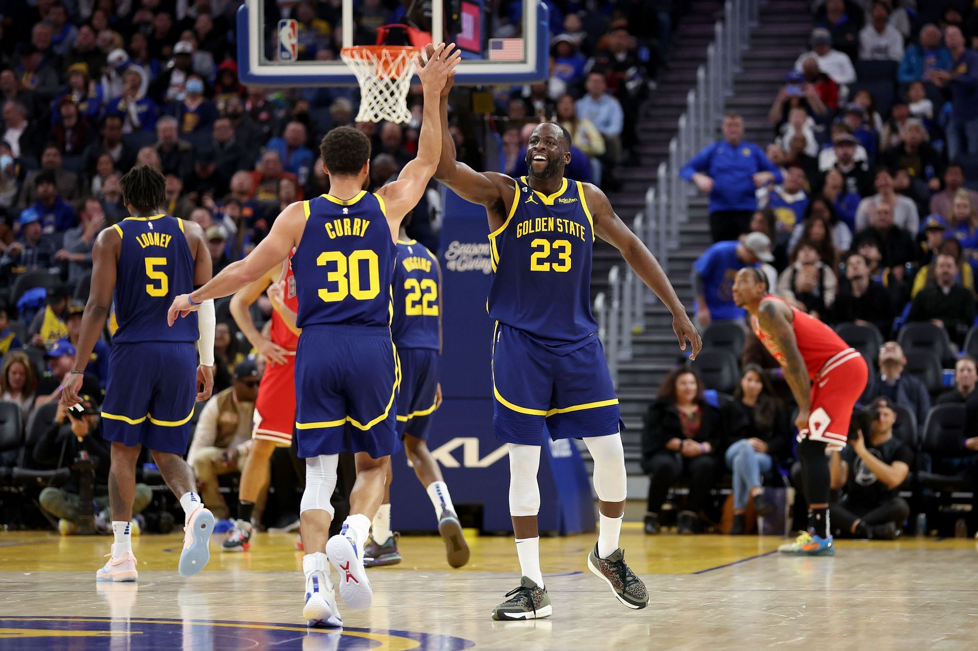 Draymond Green of the Golden State Warriors high-fives Steph Curry