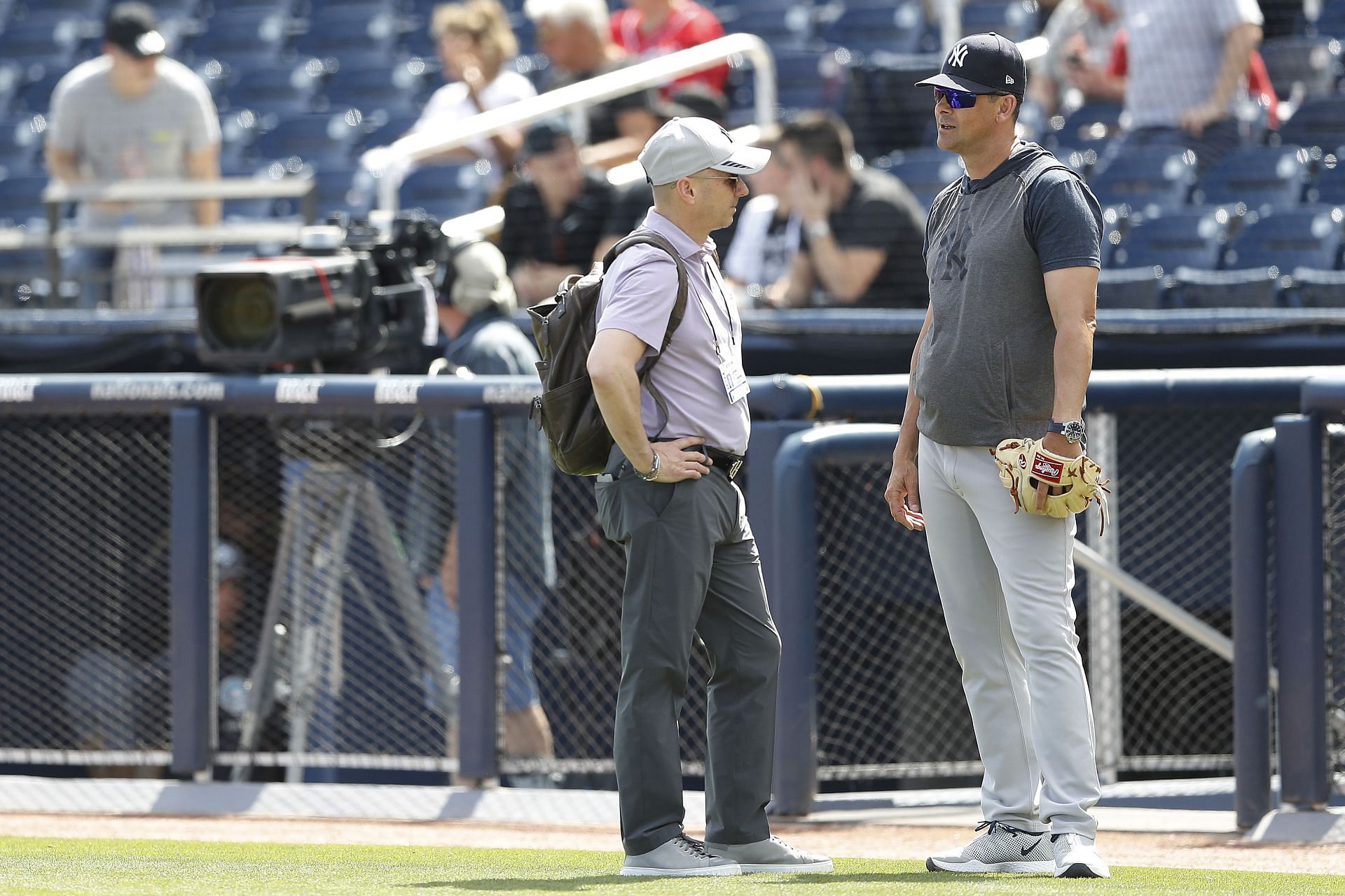 New York Yankees general manager Brian Cashman talks with manager Aaron Boone prior to a spring training game