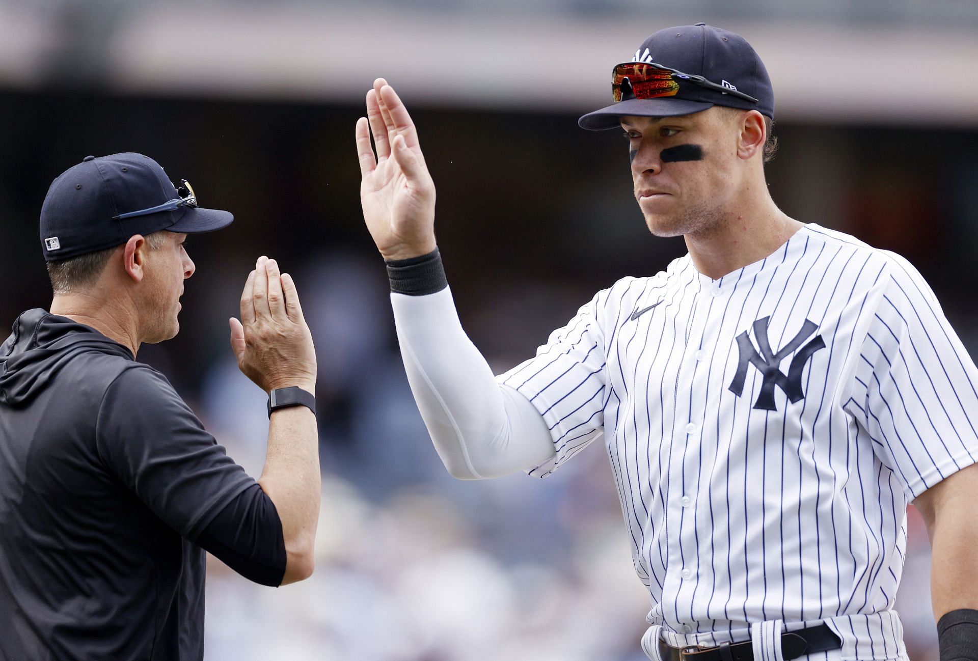 Aaron Judge high-fives manager Aaron Boone during the ninth inning against the Detroit Tigers at Yankee Stadium.