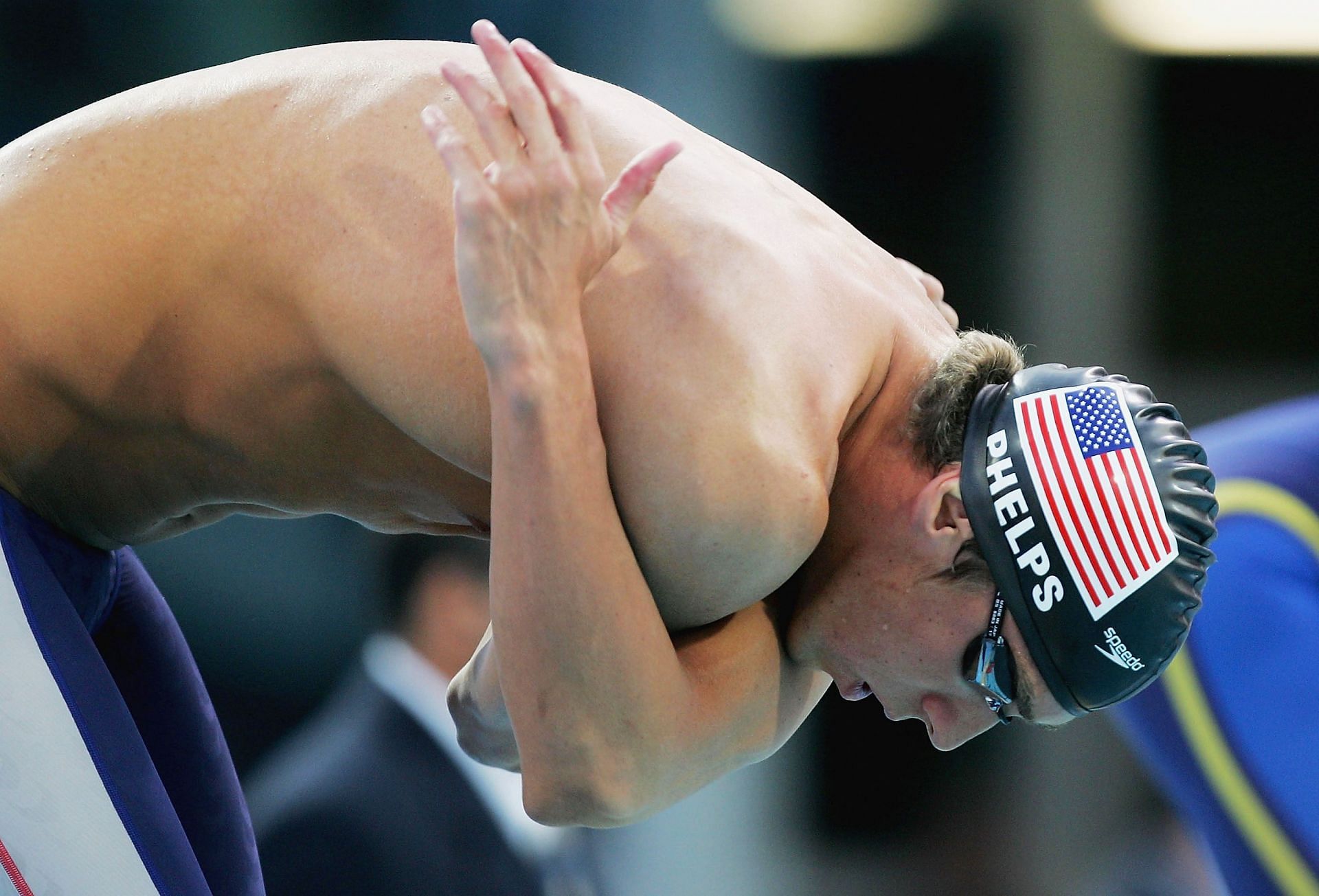 Phelps warms up for the Mens 100m Butterfly Finals 2004 (Photo by Sean Garnsworthy/Getty Images)