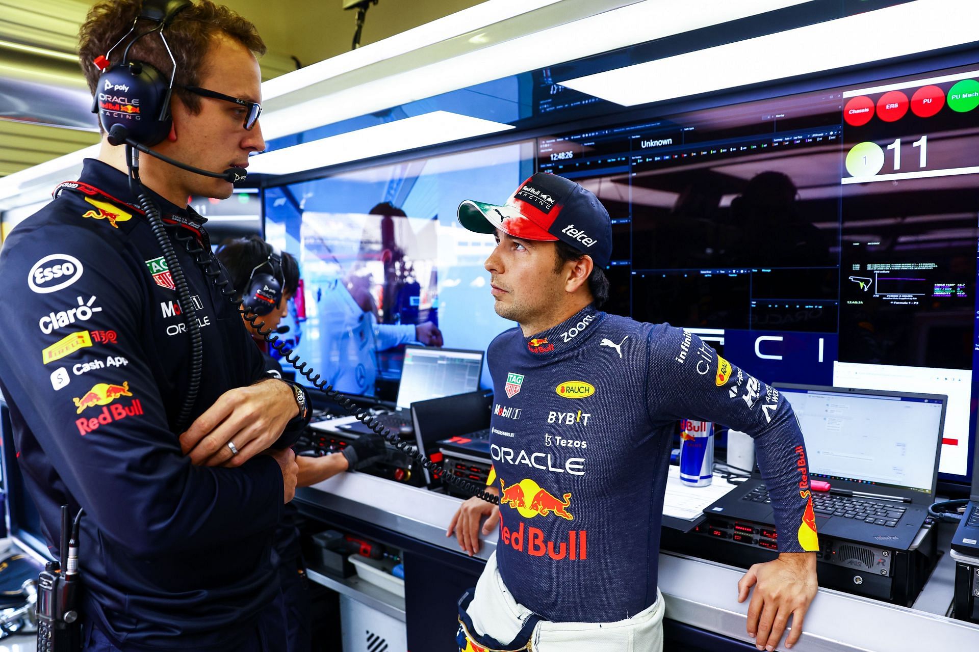 Sergio Perez of Mexico and Oracle Red Bull Racing talks with race engineer Hugh Bird in the garage during practice ahead of the F1 Grand Prix of Mexico (Photo by Mark Thompson/Getty Images)