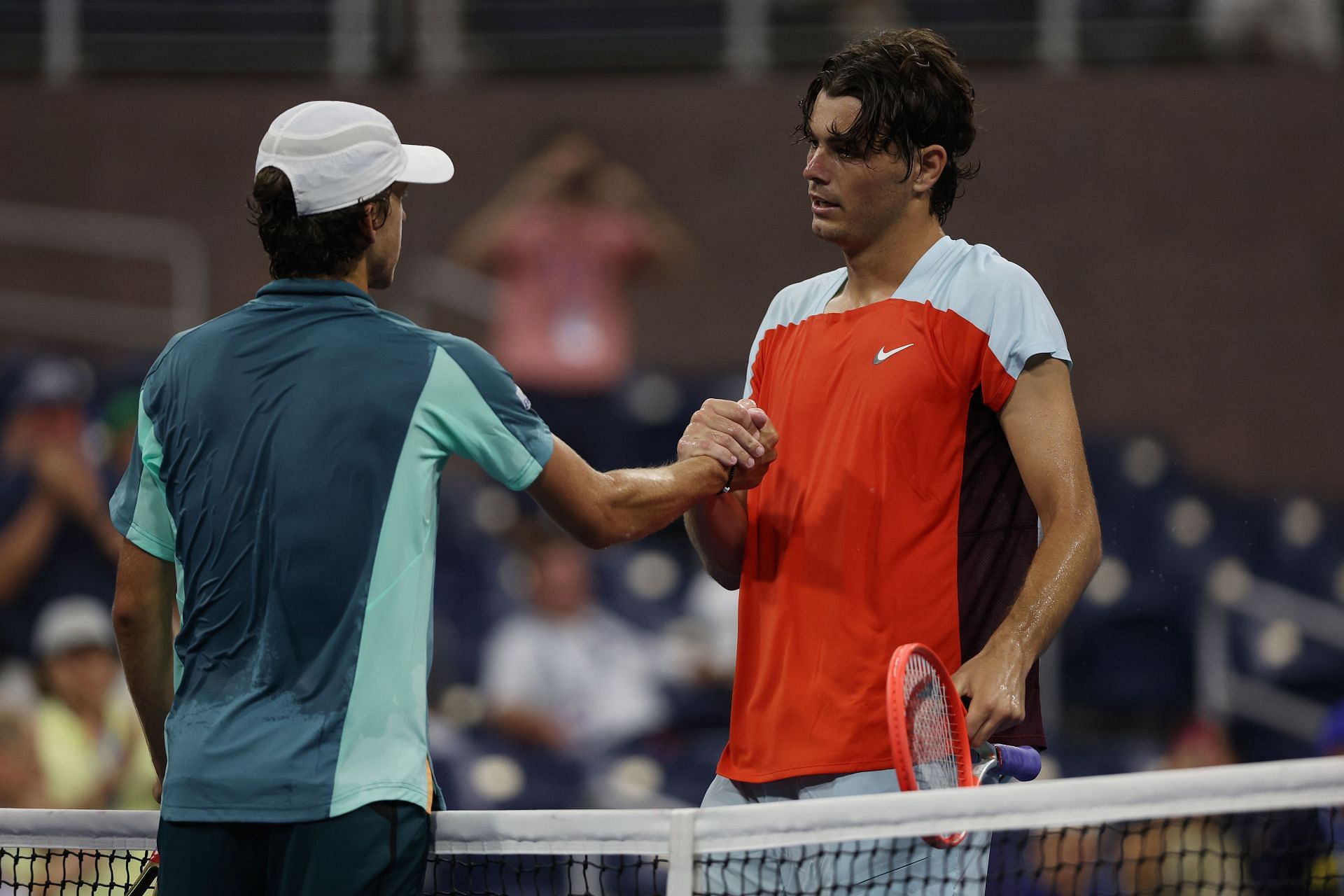 Taylor Fritz (R) shakes hands with Brandon Holt at the 2022 US Open