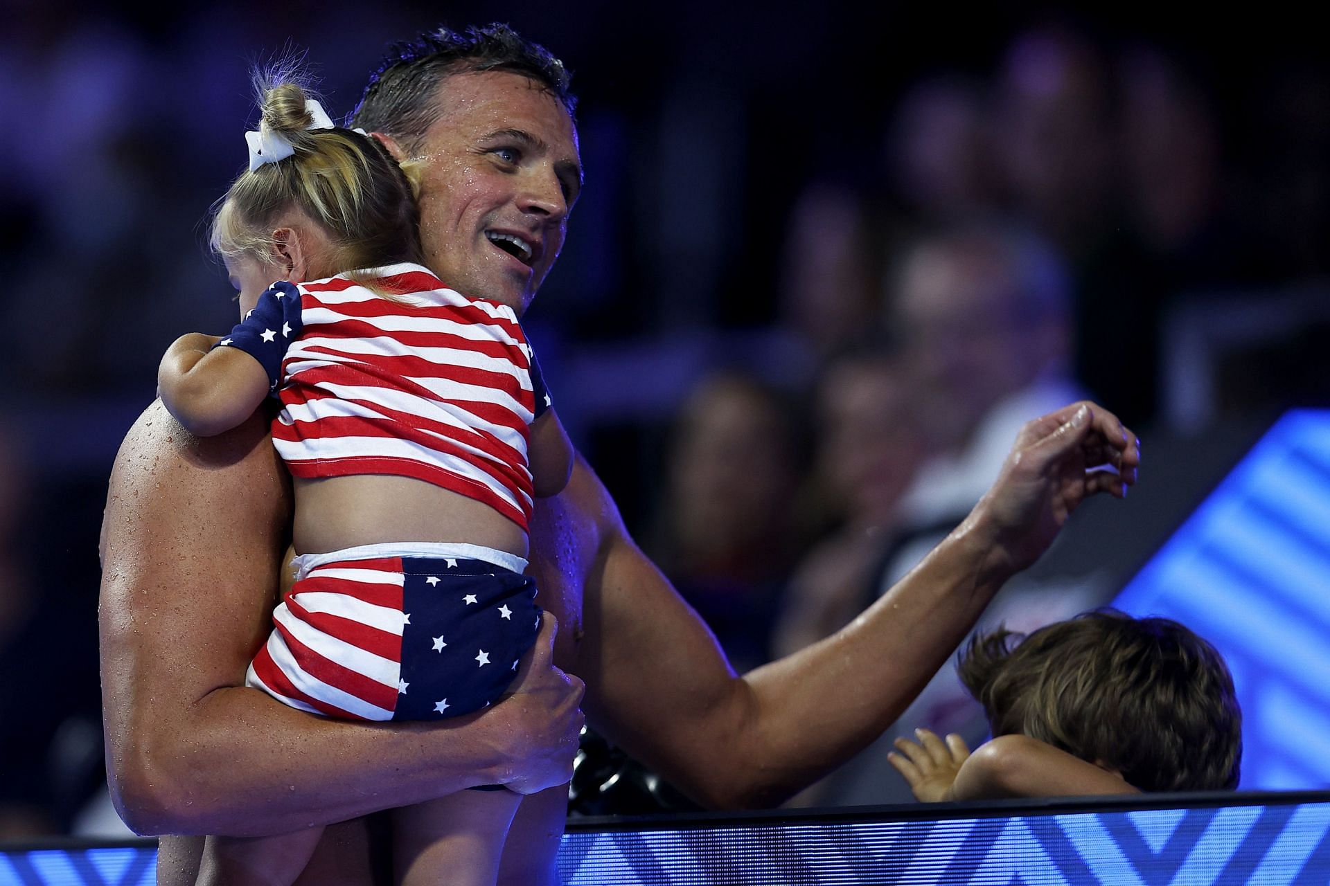 Lochte embraces his kids after the 2021 U.S. Olympic Trials (Photo by Maddie Meyer/Getty Images)