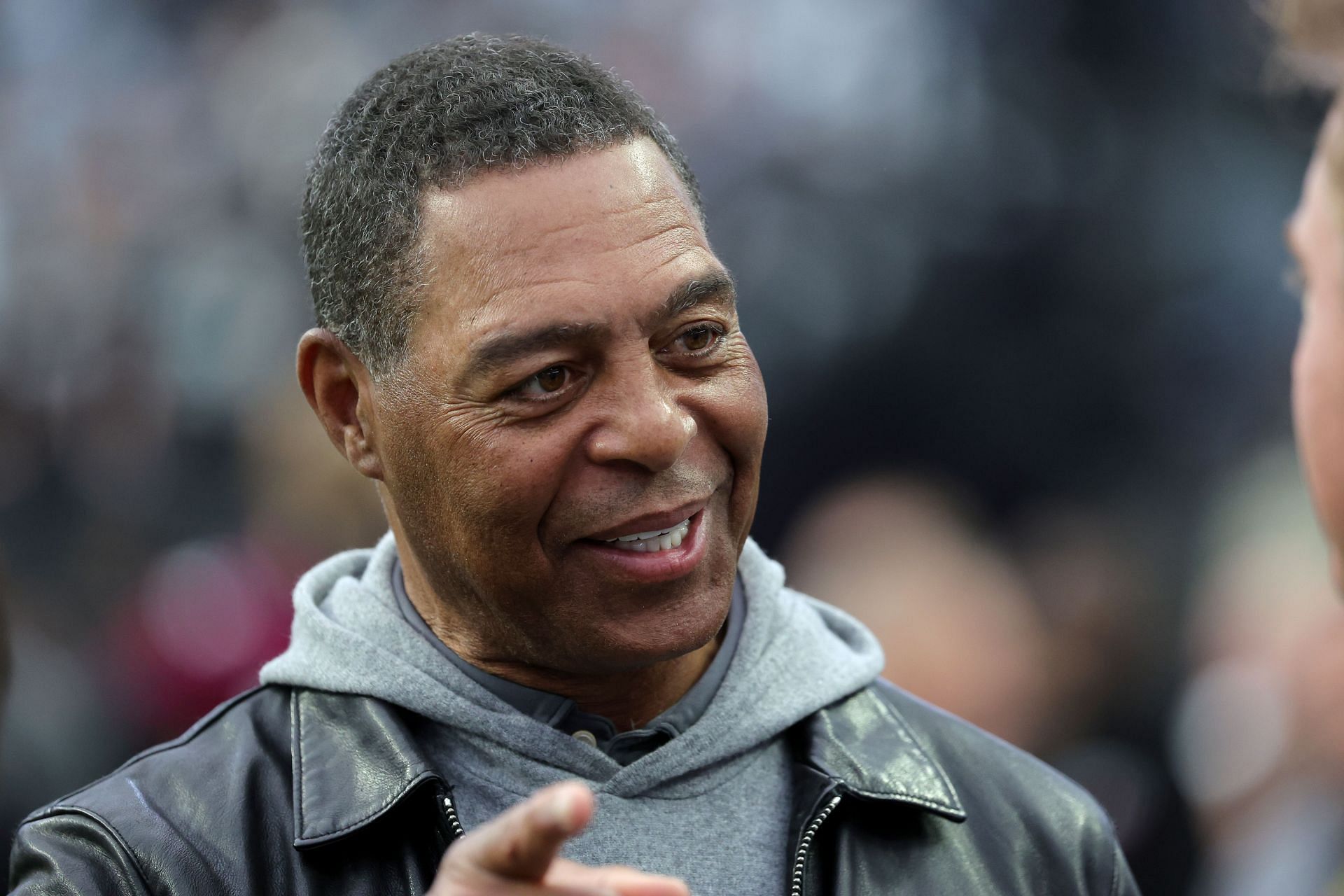 Pro Football Hall of Fame member Marcus Allen talks on the Las Vegas Raiders&#039; sideline before a game