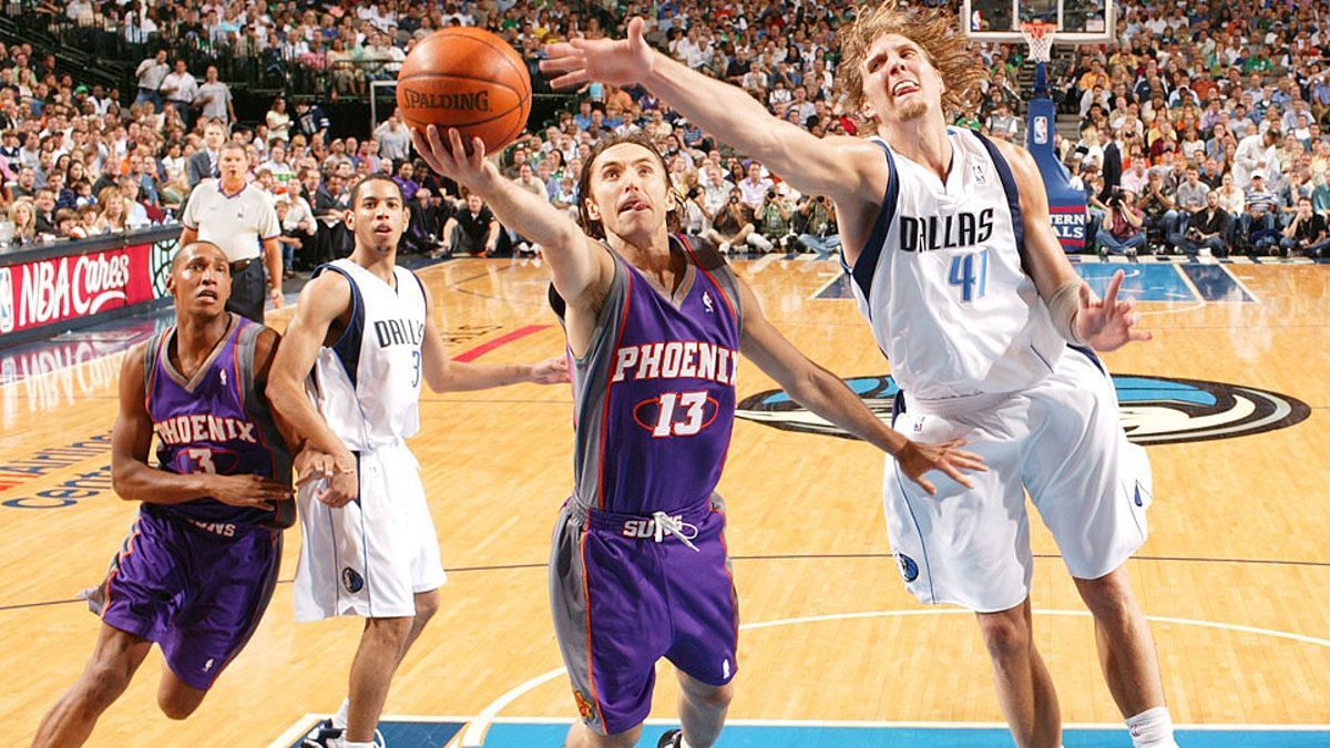 Steve Nash going for a layup against Dirk Nowitzki.