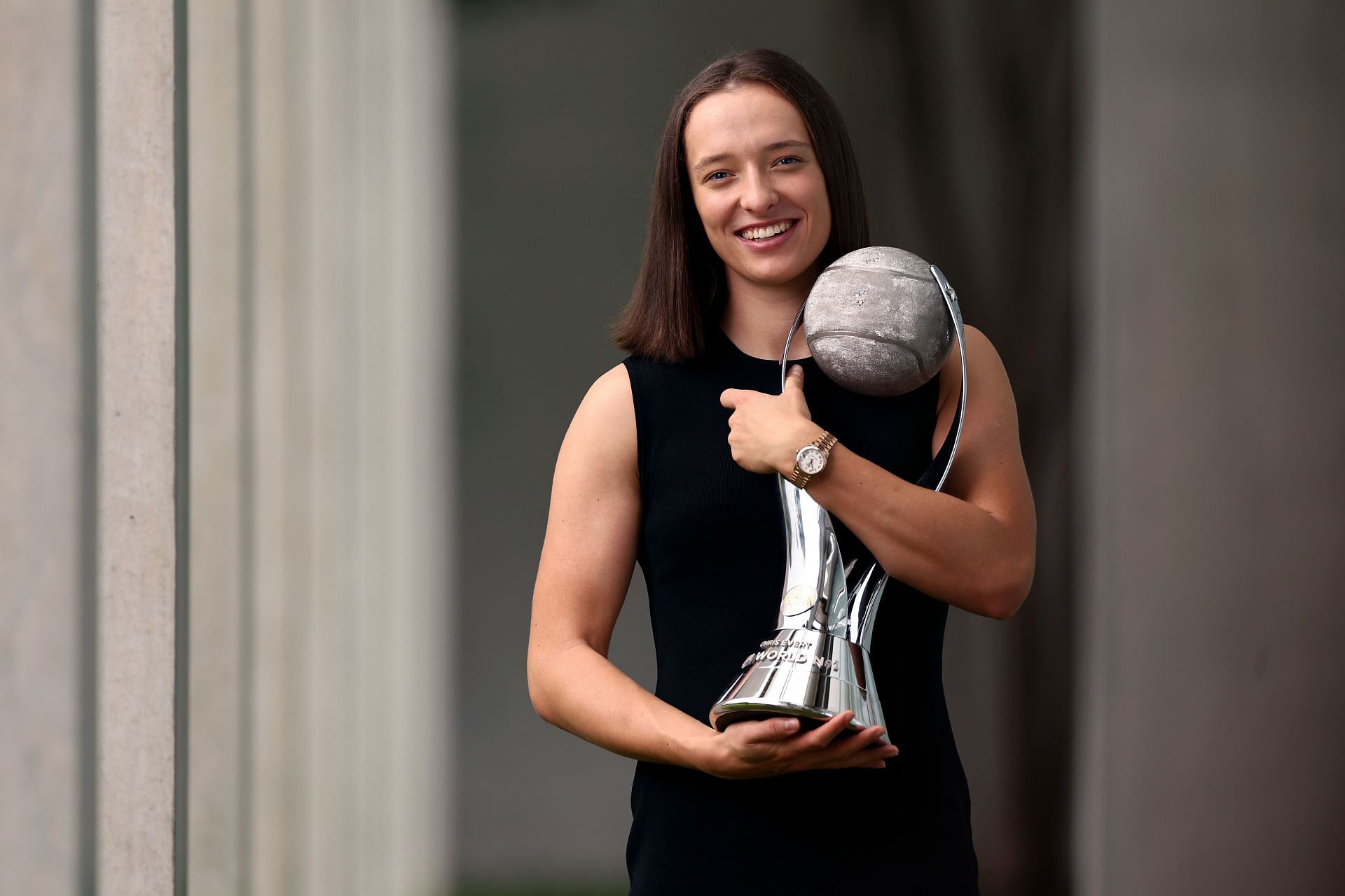 Iga Swiatek poses for a photo with the Chris Evert WTA Year-End World No. 1 Singles player trophy