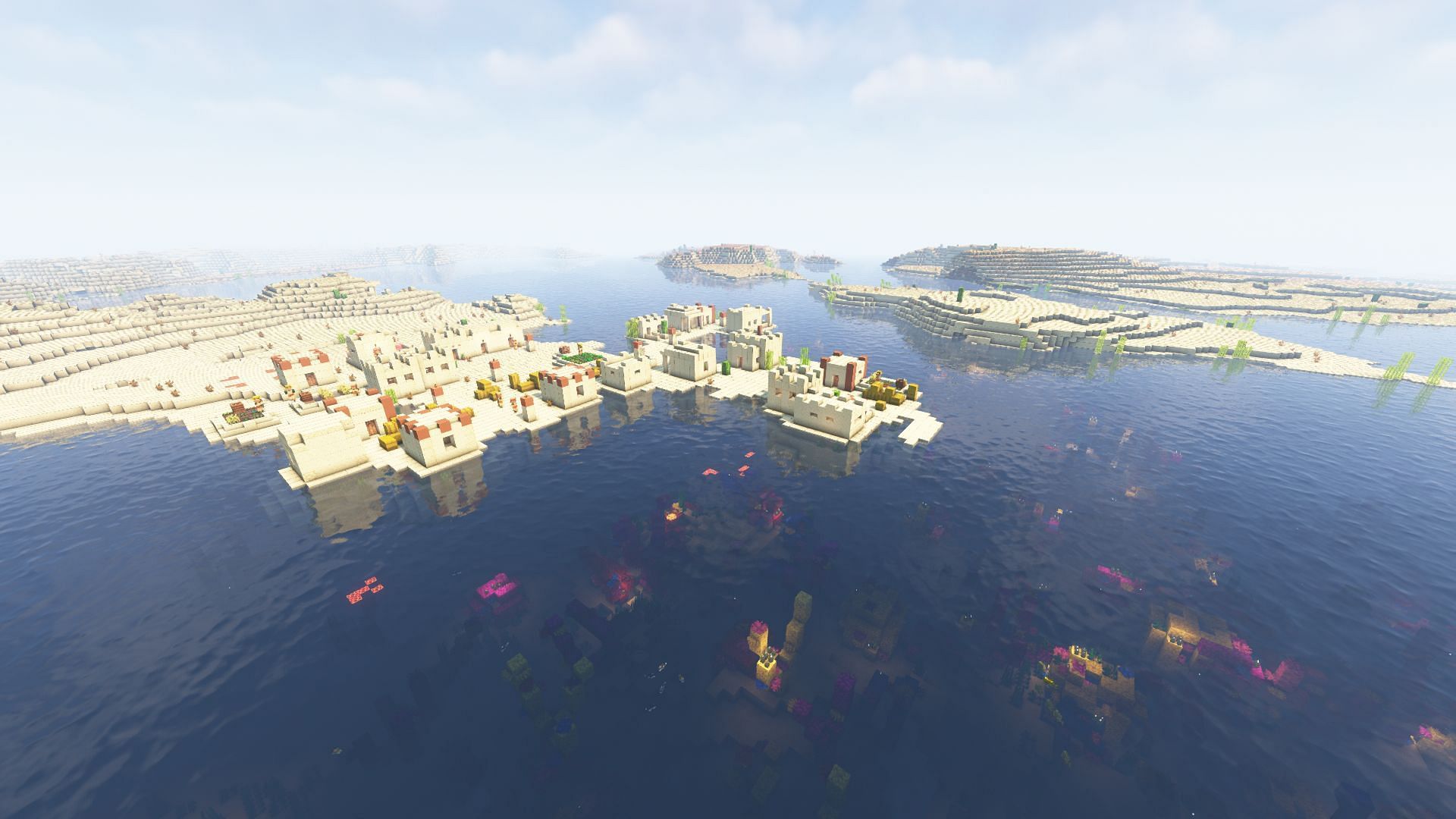 A desert village next to a warm ocean biome with coral (Image via Mojang)