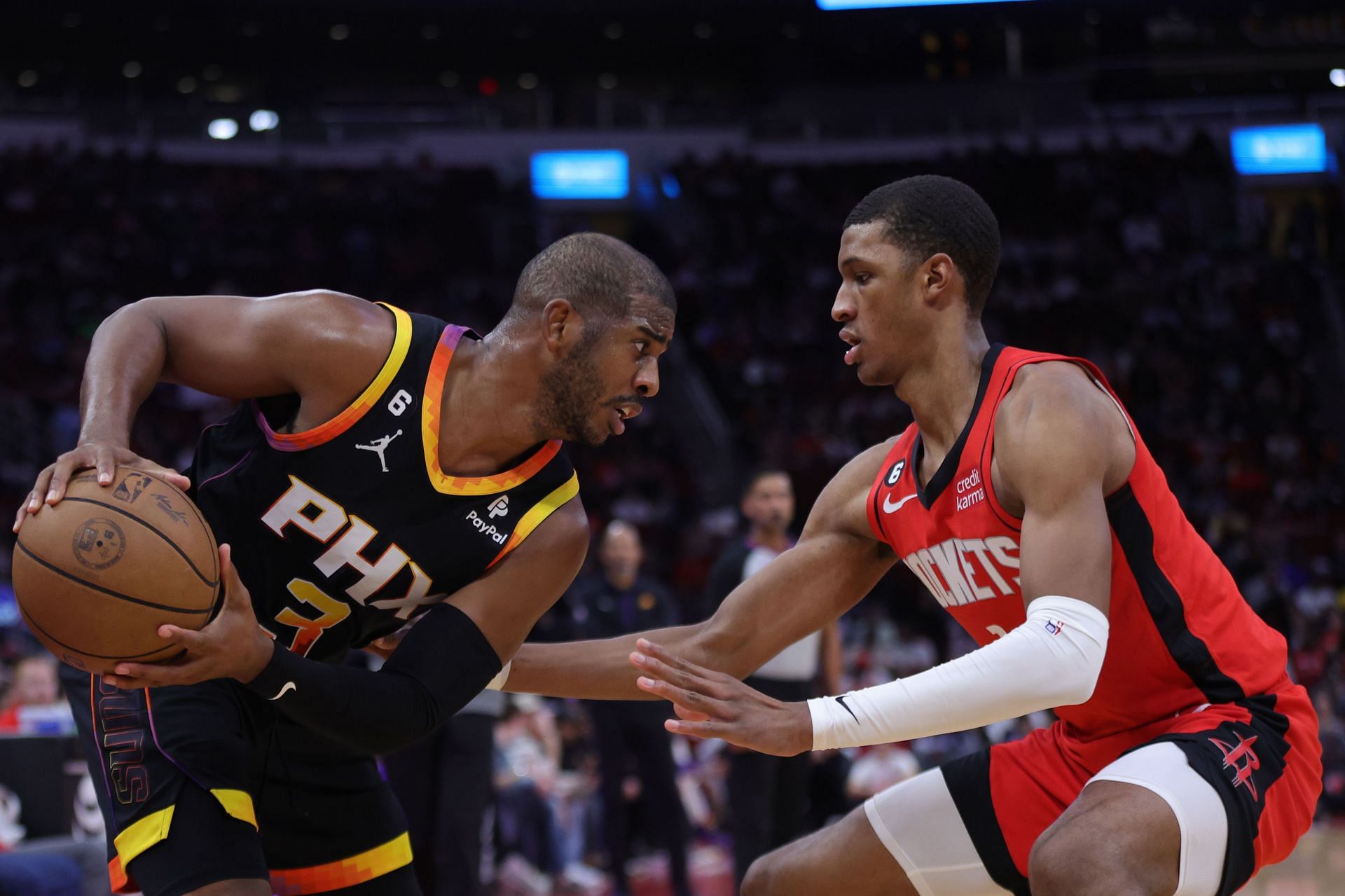 Chris Paul of the Phoenix Suns controls the ball ahead of Jabari Smith Jr. of the Houston Rockets