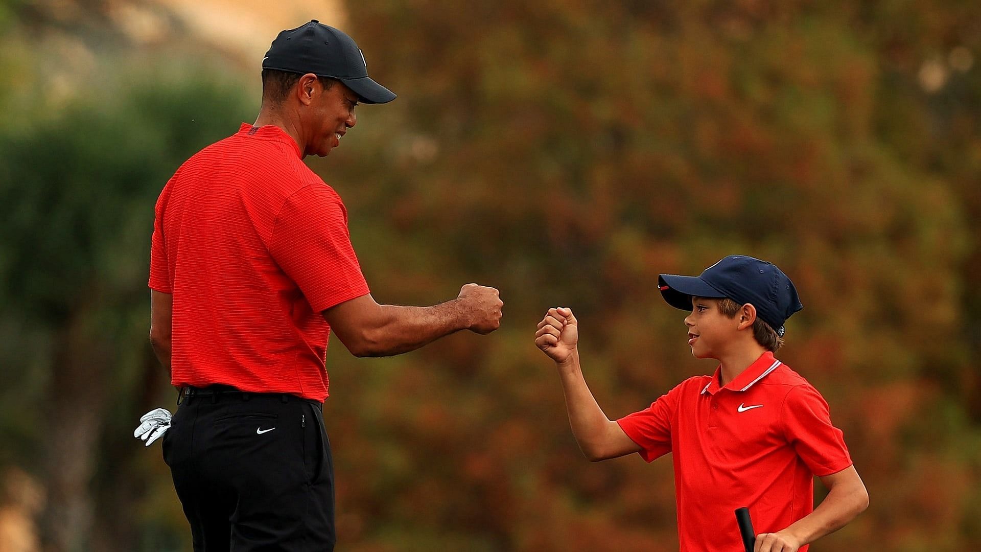 Tiger Woods fist bumping his son 
