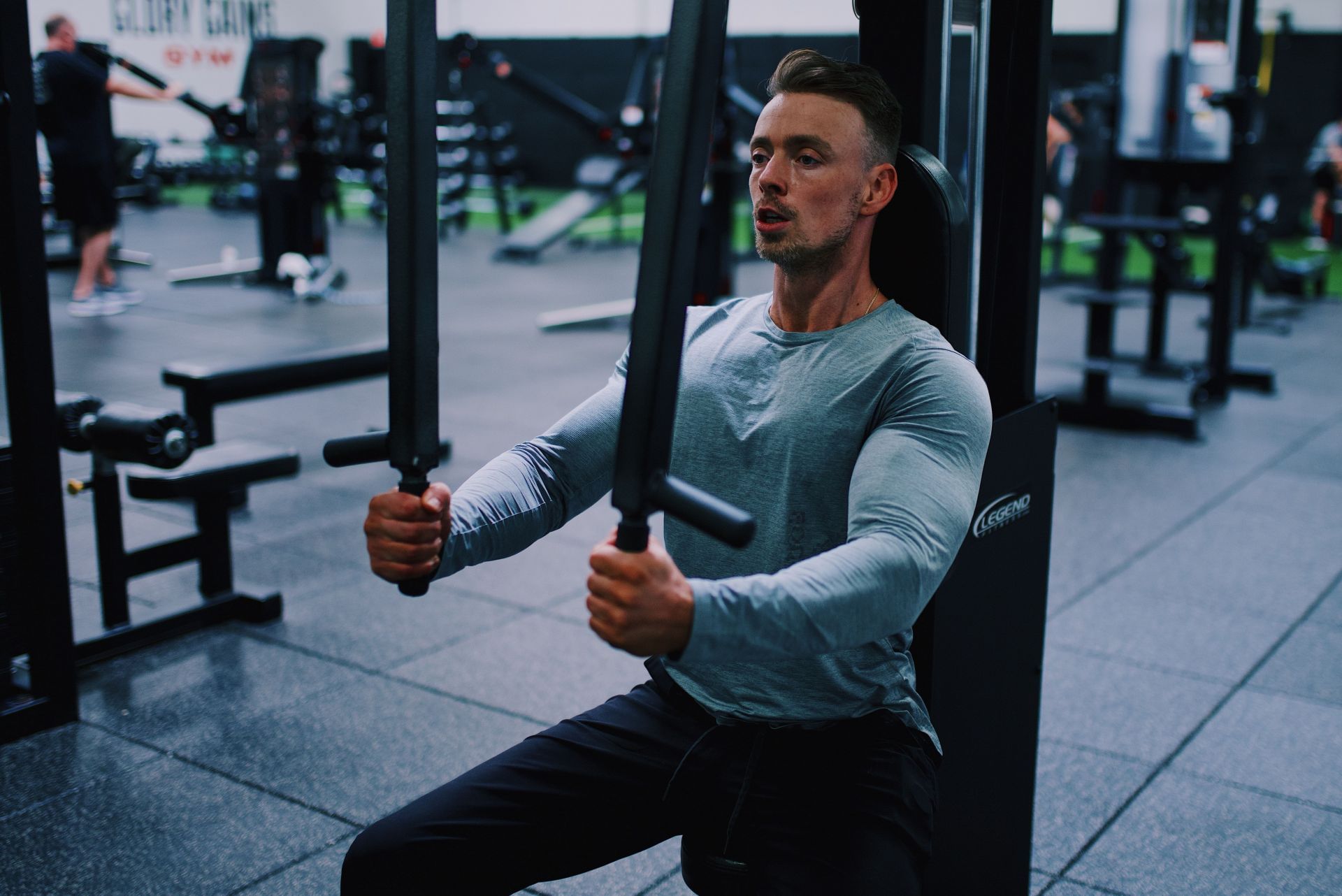 Chest workout machines are a great option to build your pecs. (Image via Unsplash/ Gordon Cowie)