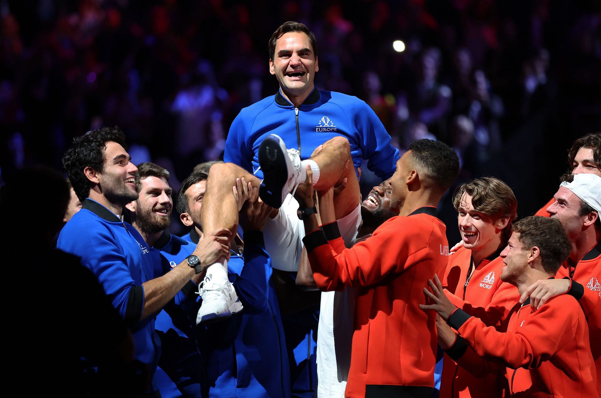 Federer being lifted up by his teammates and members of Team World