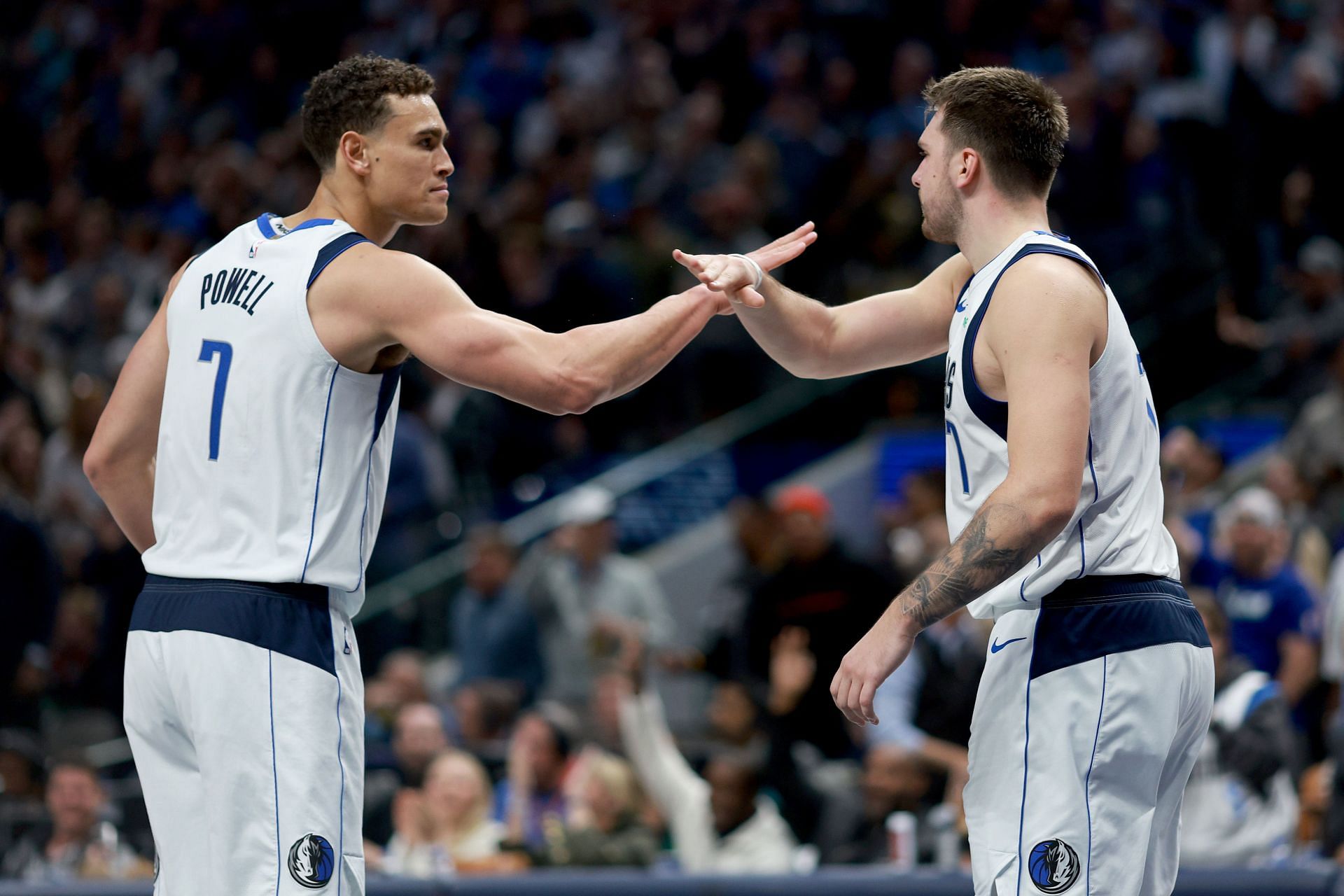 Luka Doncic celebrates with Dwight Powell #7 of the Dallas Mavericks