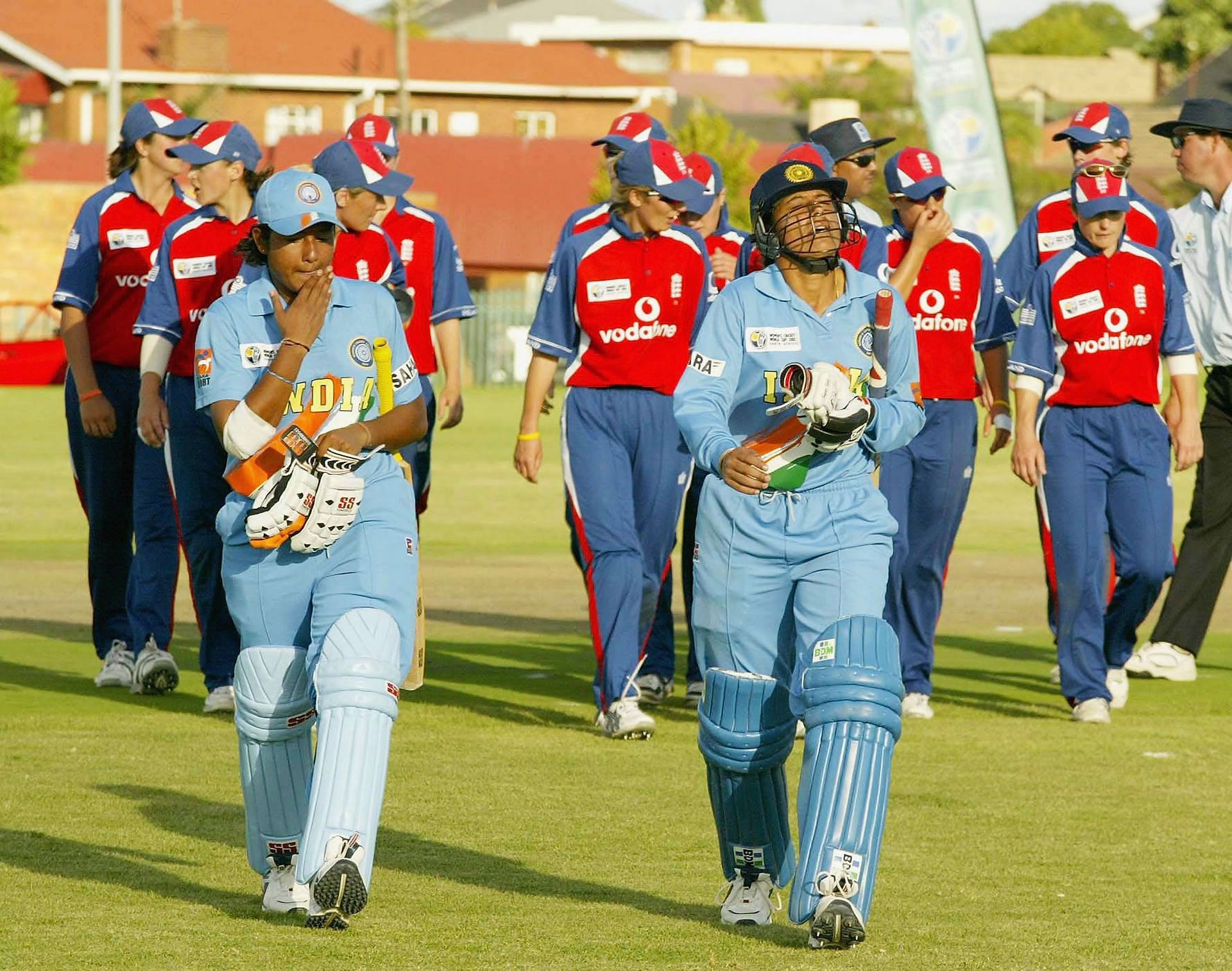 Anjum Chopra and Rumeli Dhar of India lead England off the field during the England v India Women&#039;s World Cup match on March 28, 2005, at Laudium Cricket Oval in Pretoria, South Africa. (Photo by: Getty)