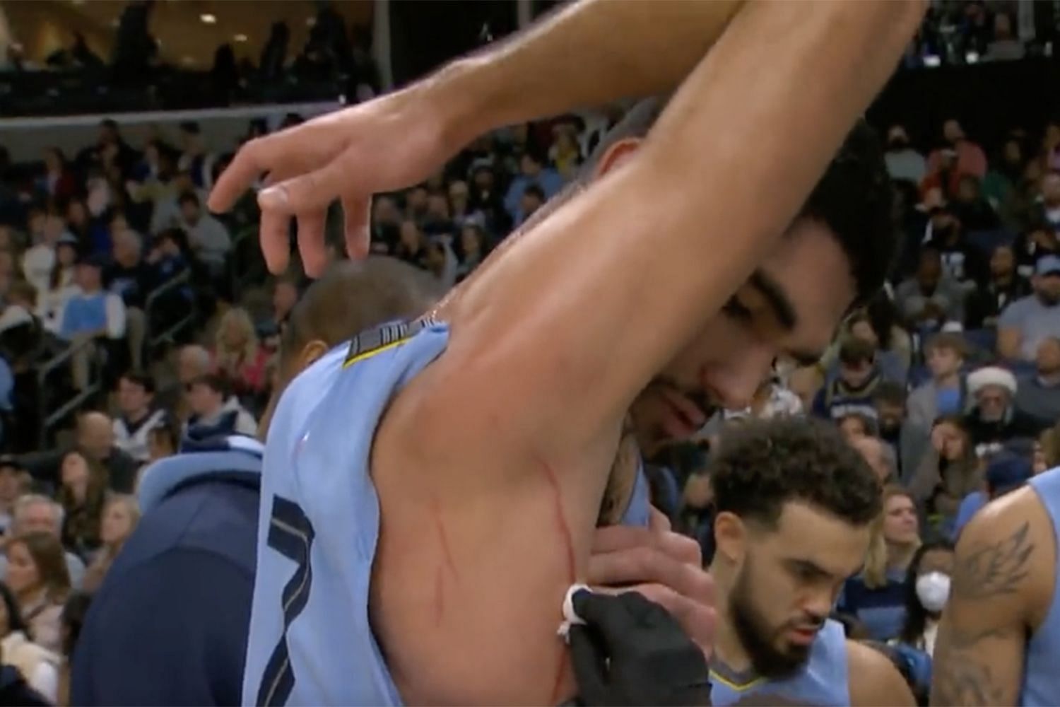 Memphis Grizzlies forward Santi Aldama gets tended to by team medical staff