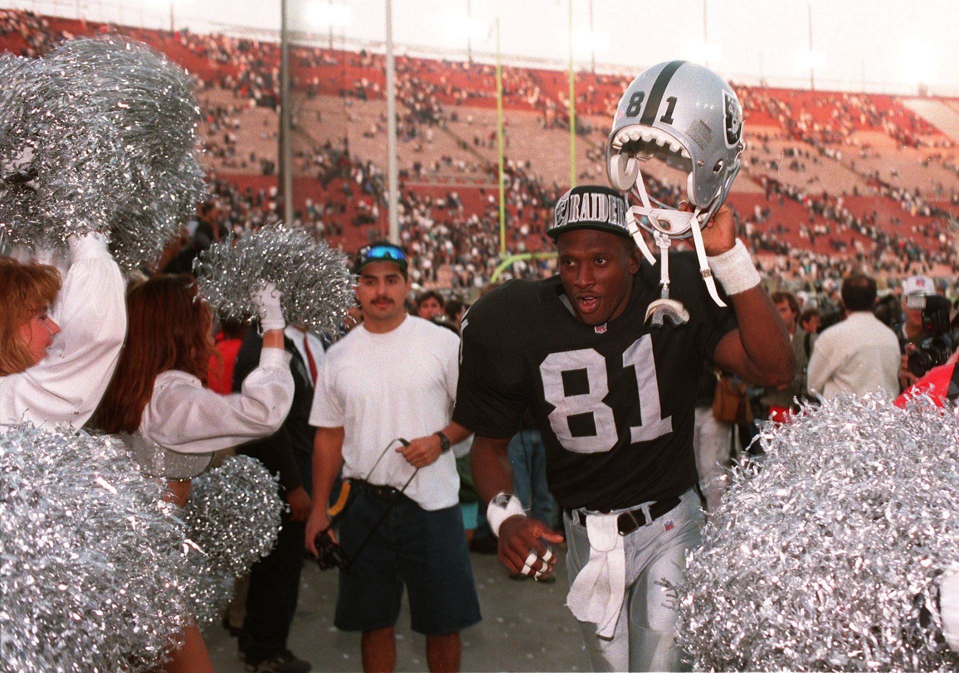 Tim Brown of the Los Angeles Raiders with his helmet aloft