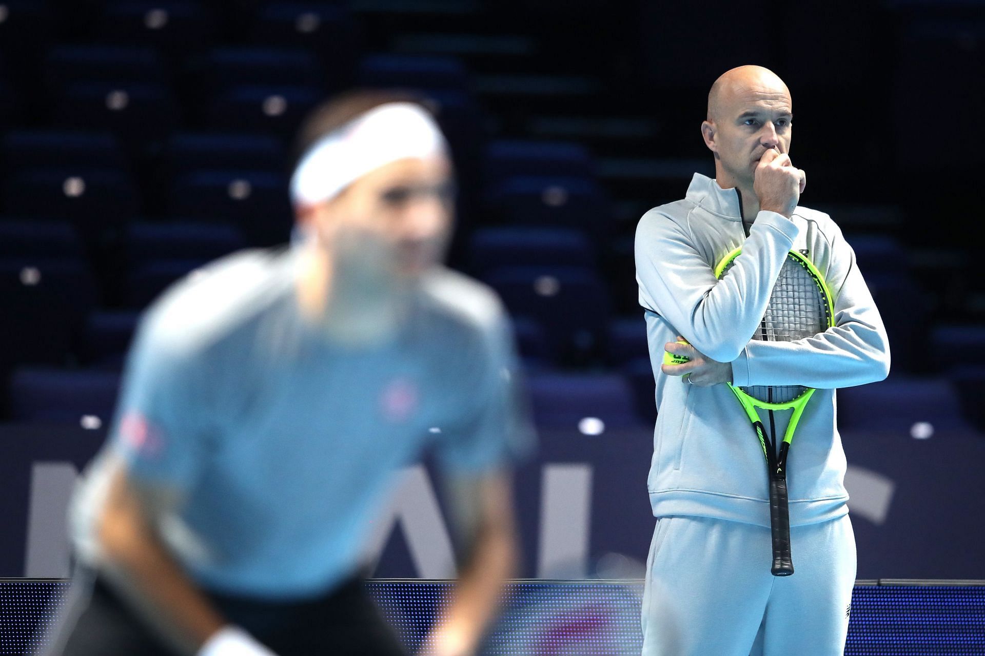 Ivan Ljubicic [right] watches Roger Federer train at the 2019 ATP Finals.