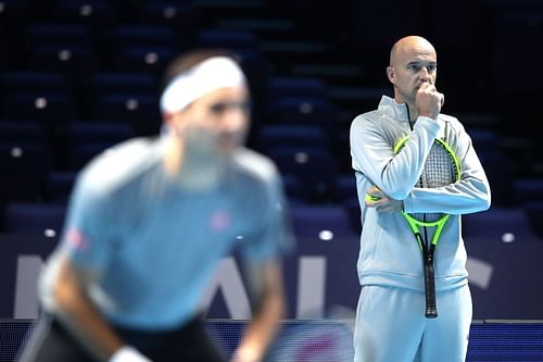 Ivan Ljubicic [right] watches Roger Federer train at the 2019 ATP Finals.