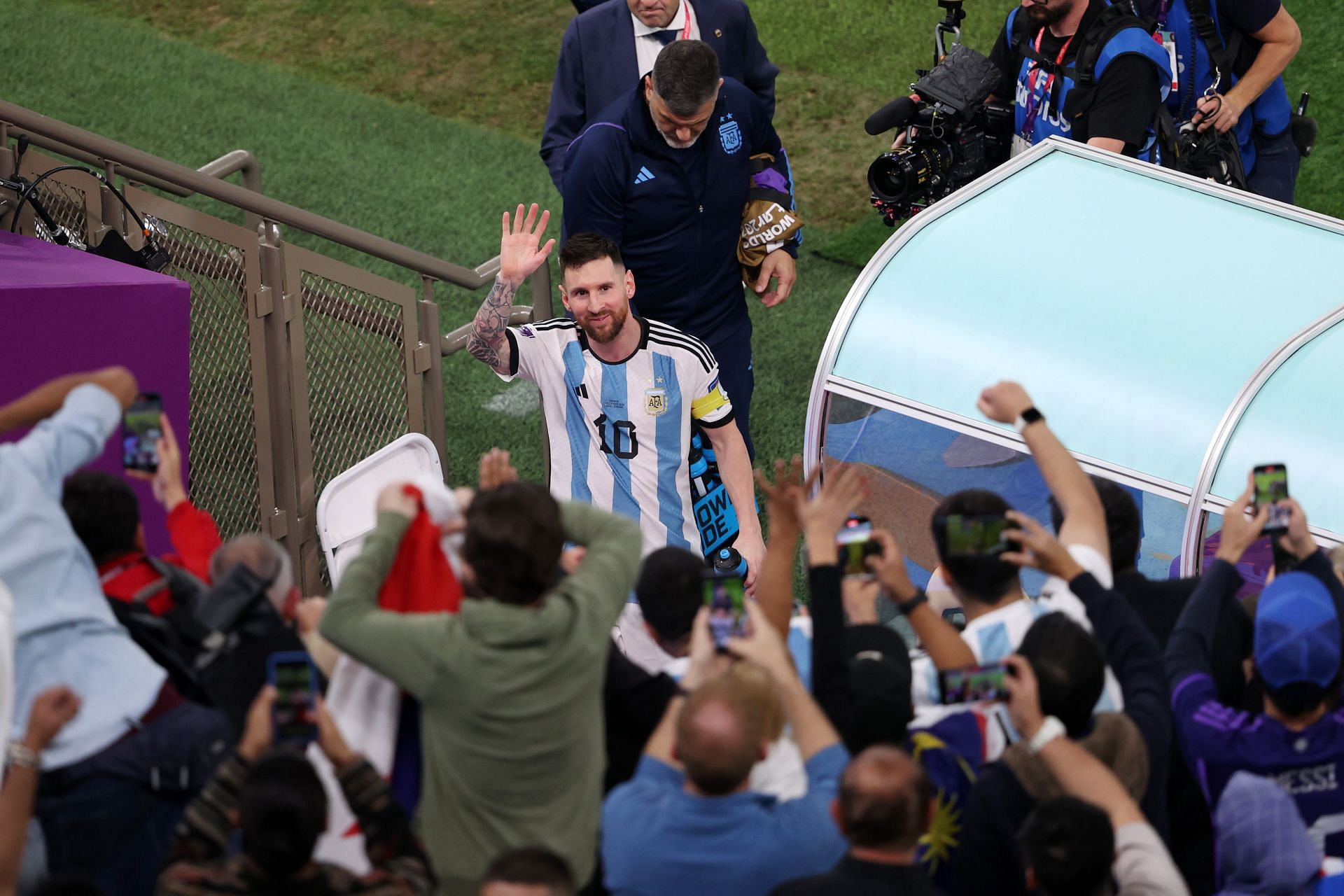 Lionel Messi greets fans after the semi-final vs Croatia