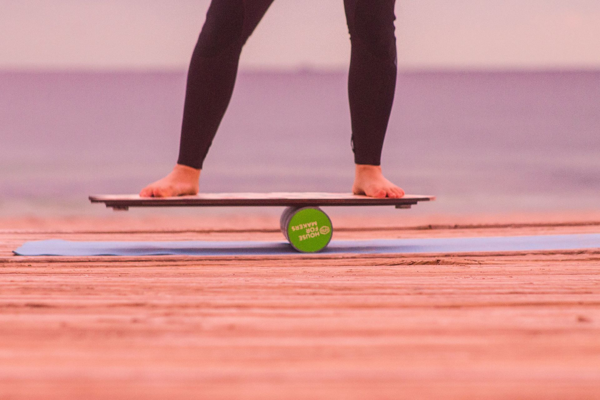Balance board exercises are a great way to strengthen your core. (Image via Unsplash / Gustavo Torres)