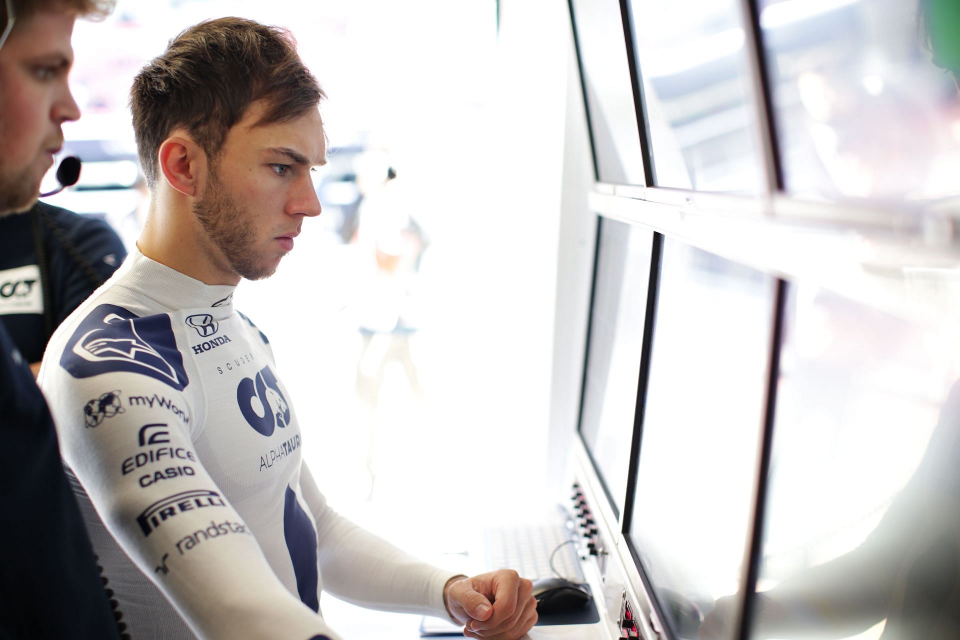 Pierre Gasly of France and Scuderia AlphaTauri examines data in the garage during day two of F1 Winter Testing. (Photo by Peter Fox/Getty Images)