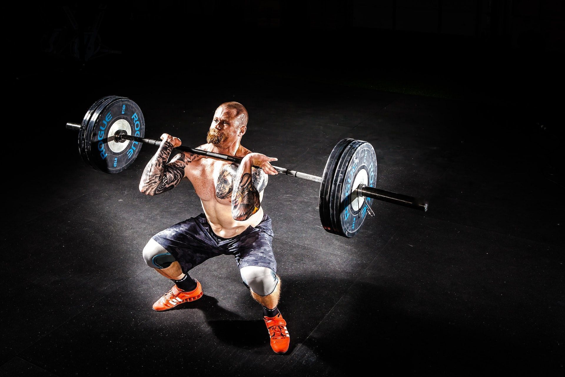 Barbell front raise exercise builds shoulder strength and stability. (Photo via Pexels/Binyamin Mellish)
