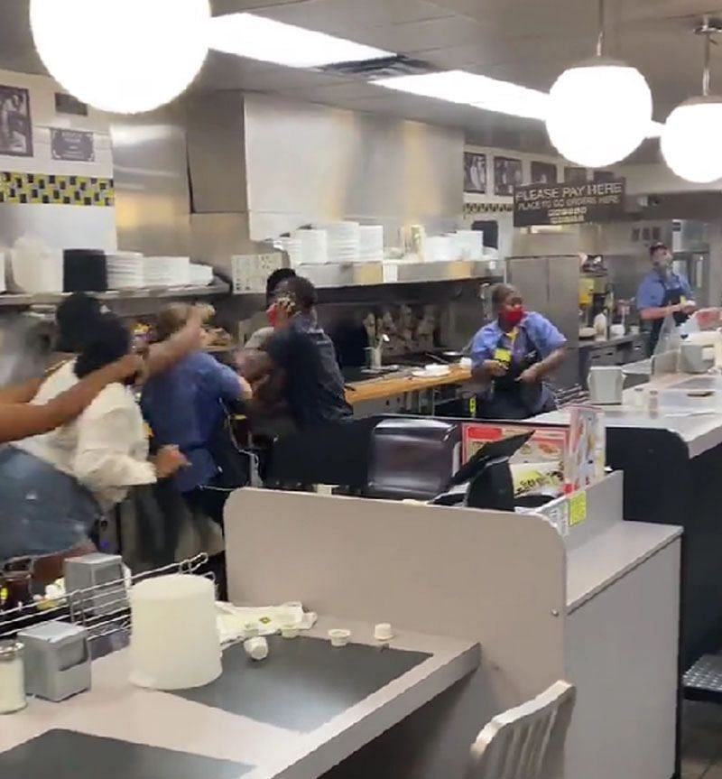 Image showing a worker punching while another stands with a pan (Image via Twitter/@rbaylor_74)