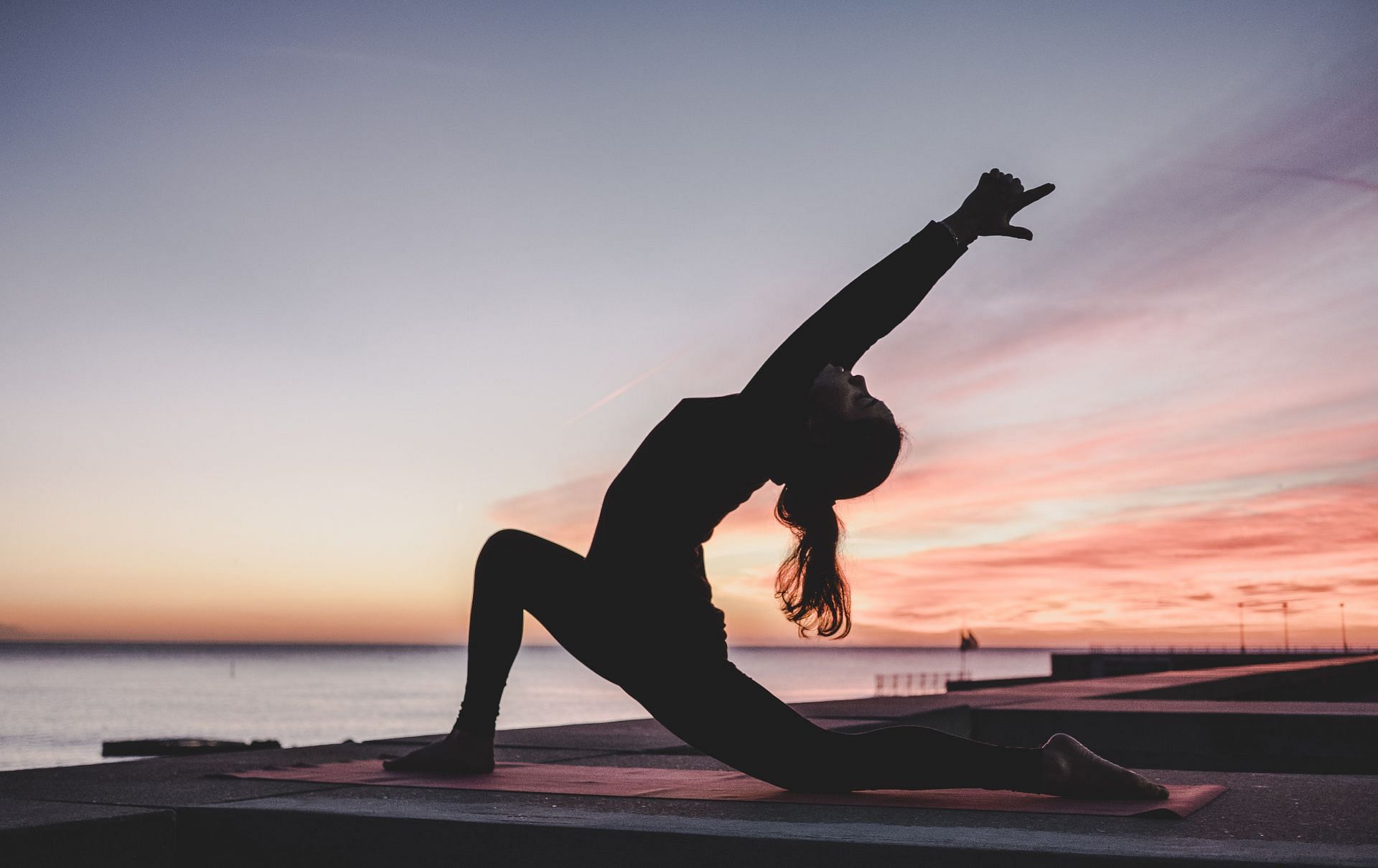 Simple yoga poses can be a great way to stretch in the morning. (Image via Unsplash / Kike Vega)