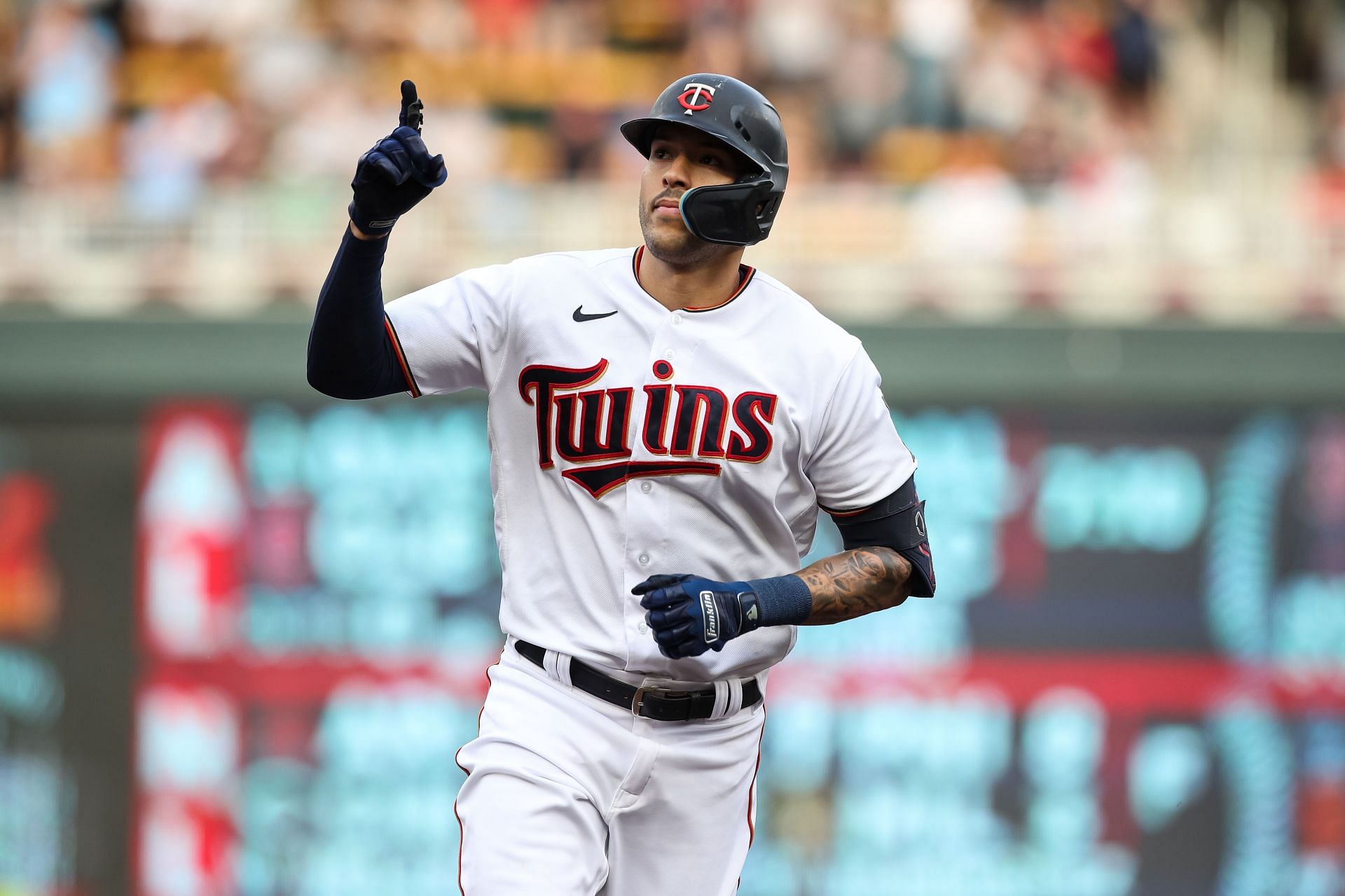 Carlos Correa of the Minnesota Twins celebrates his solo home run as he rounds the bases.