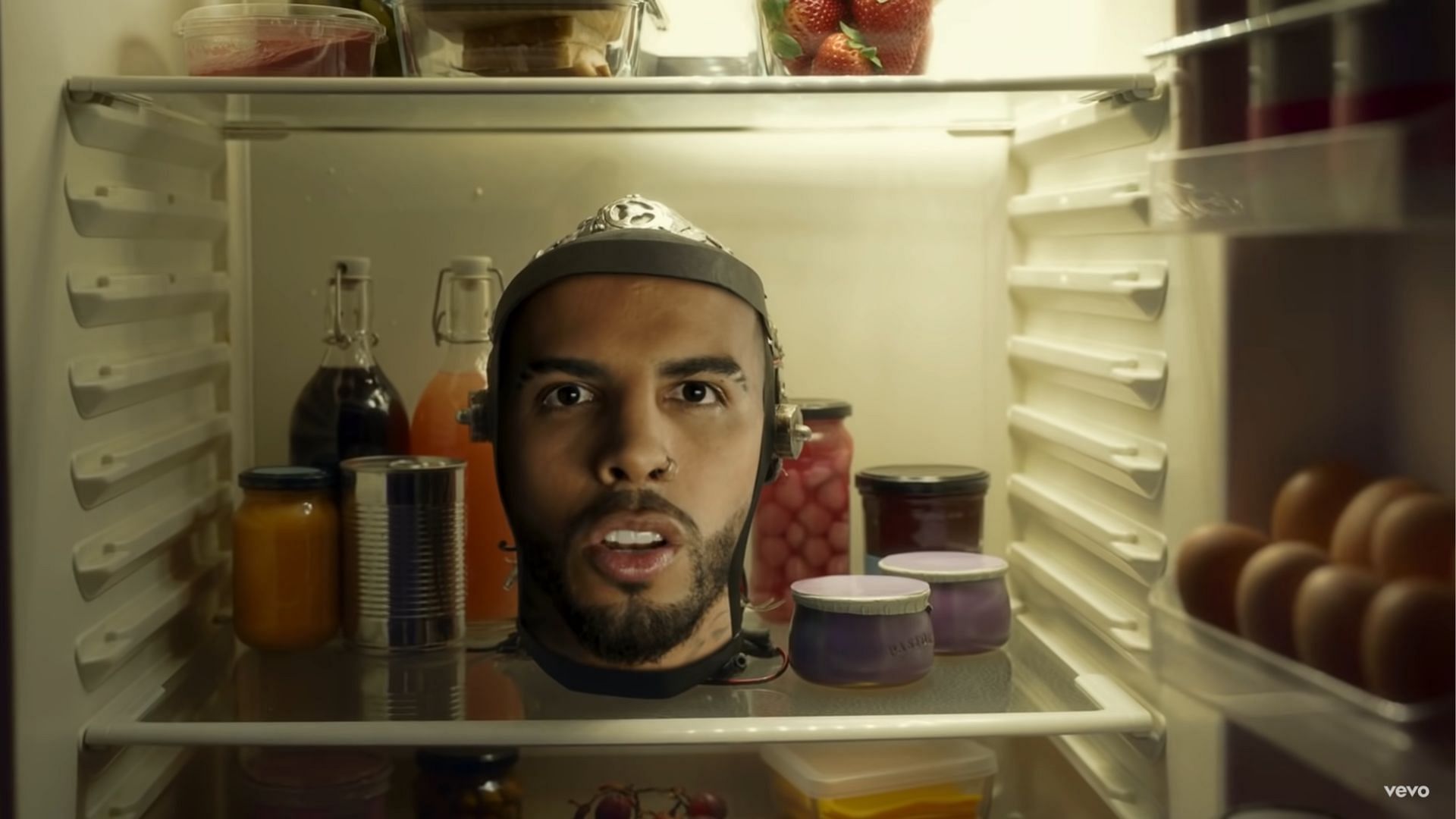 Te Felicito&#039;s music video shows Shakira opening the fridge to find her collaborator&#039;s head surrounded by strawberry products (Image via YouTube).