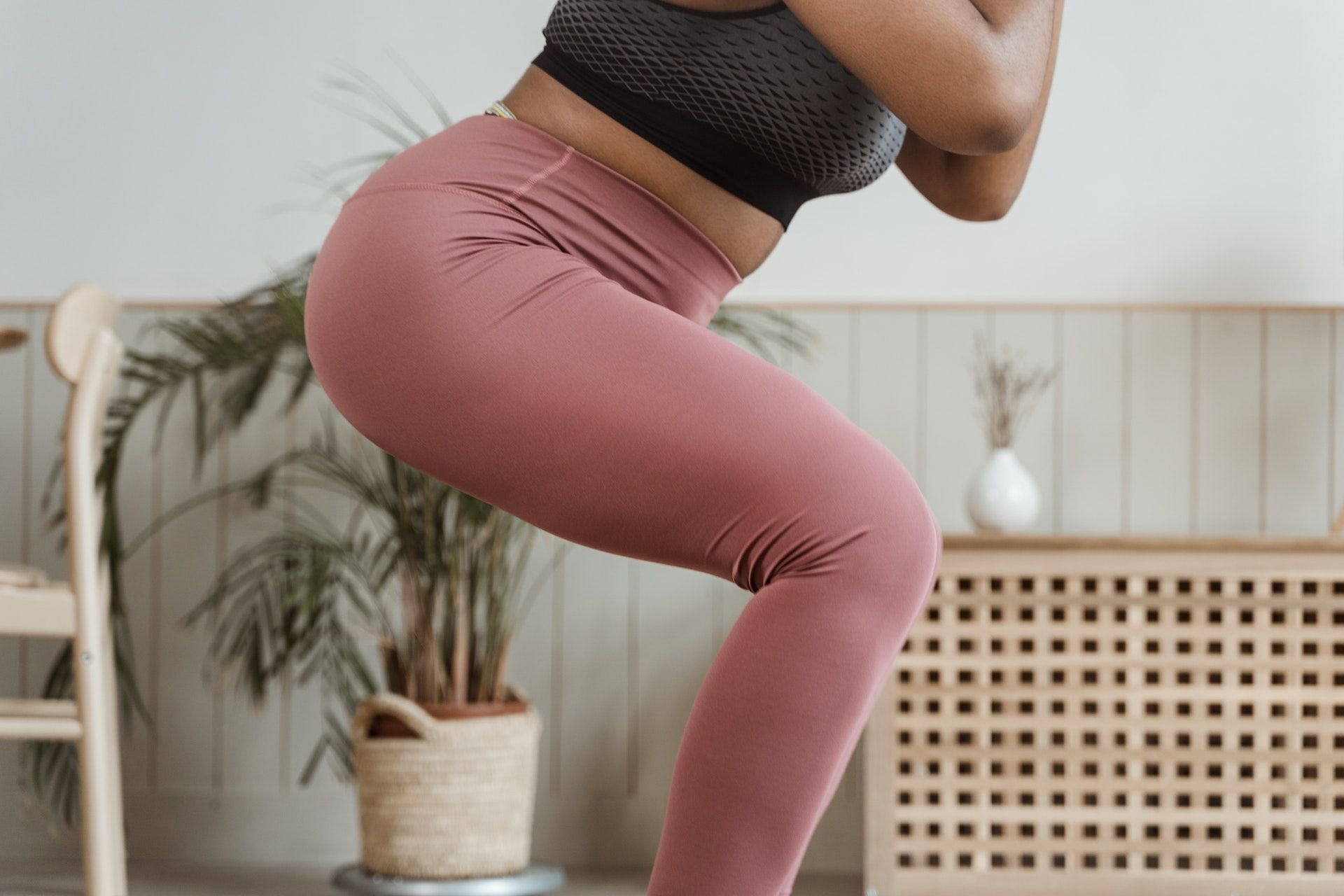 Squats work the entire lower-body muscles. (Photo via Pexels/MART PRODUCTION)