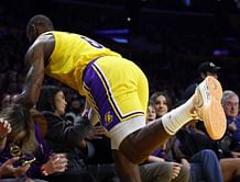 Watch: LeBron James puts his body on the line by diving over the front-row seats to secure a loose ball