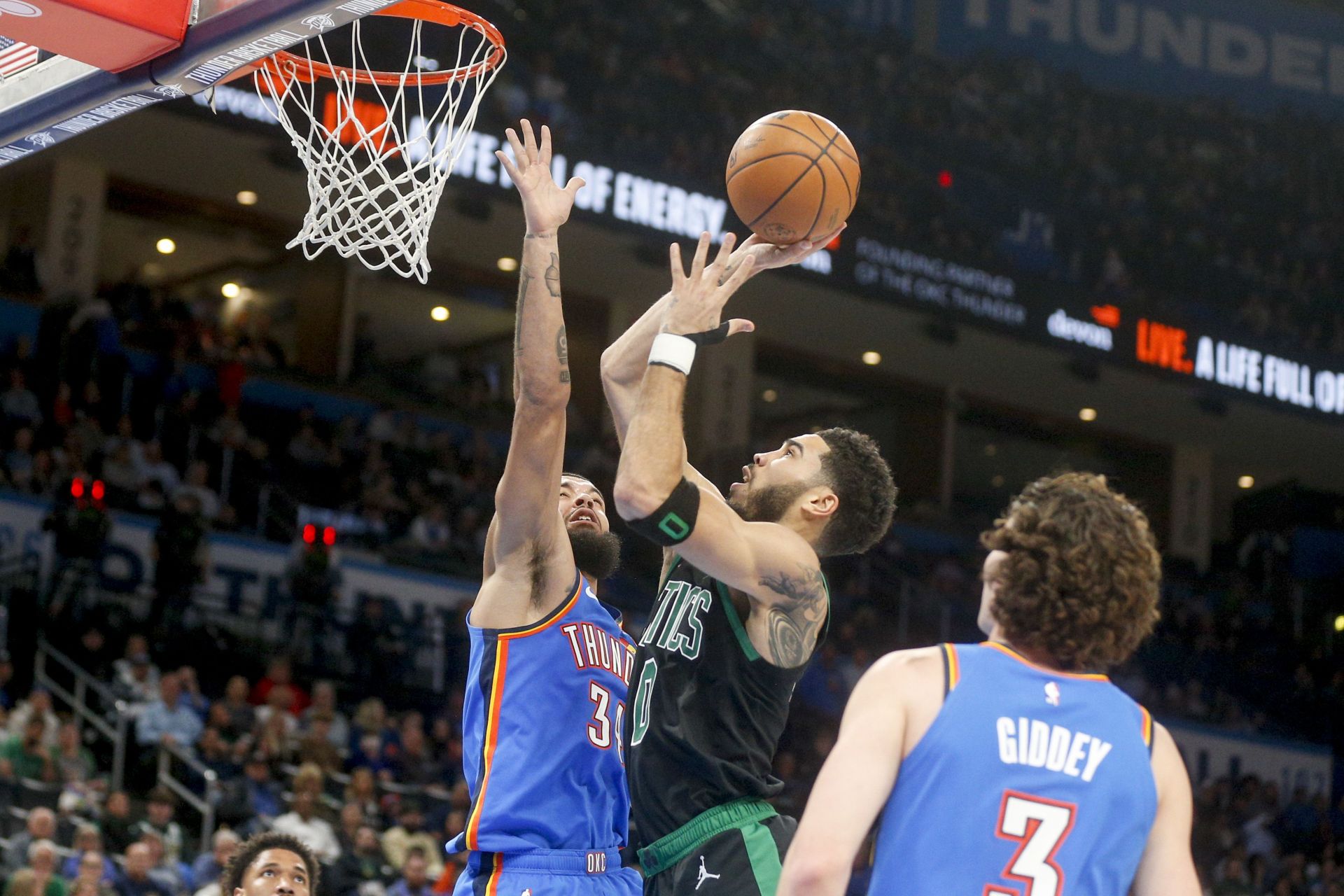 Boston Celtics superstar forward Jayson Tatum (center) in action against the OKC Thunder