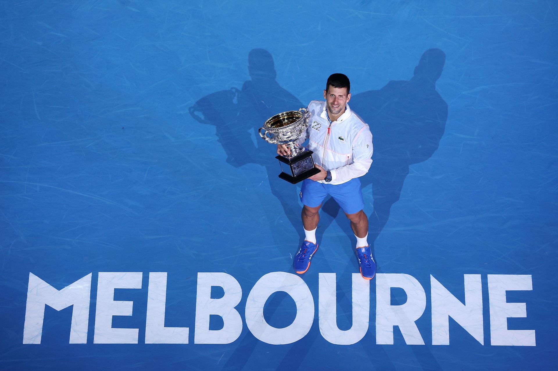 Novak Djokovic poses with the Norman Brookes Challenge Cup after beating Stefanos Tsitsipas