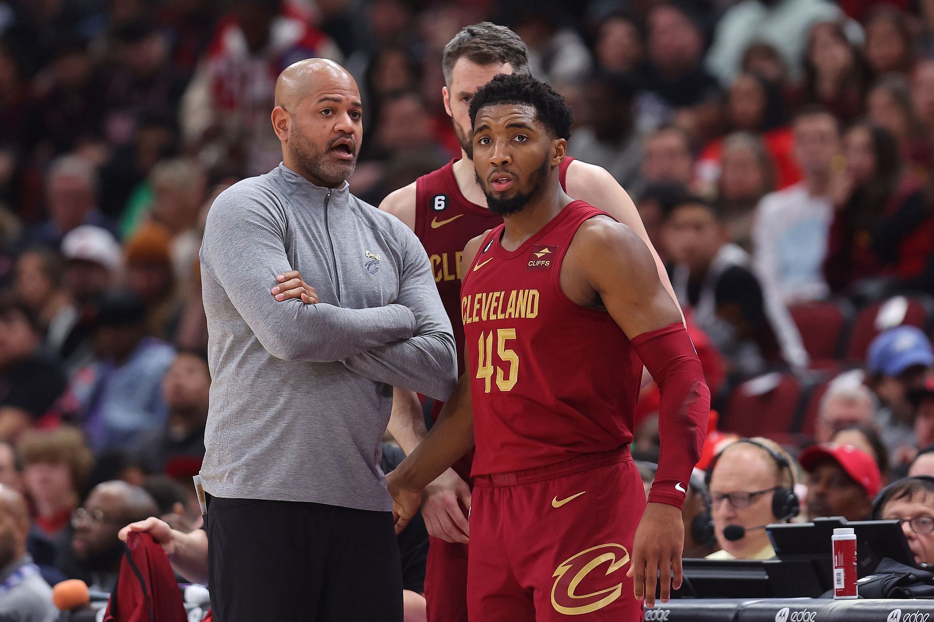 Cleveland Cavaliers coach J.B. Bickerstaff speaking with All-Star shooting guard Donovan Mitchell