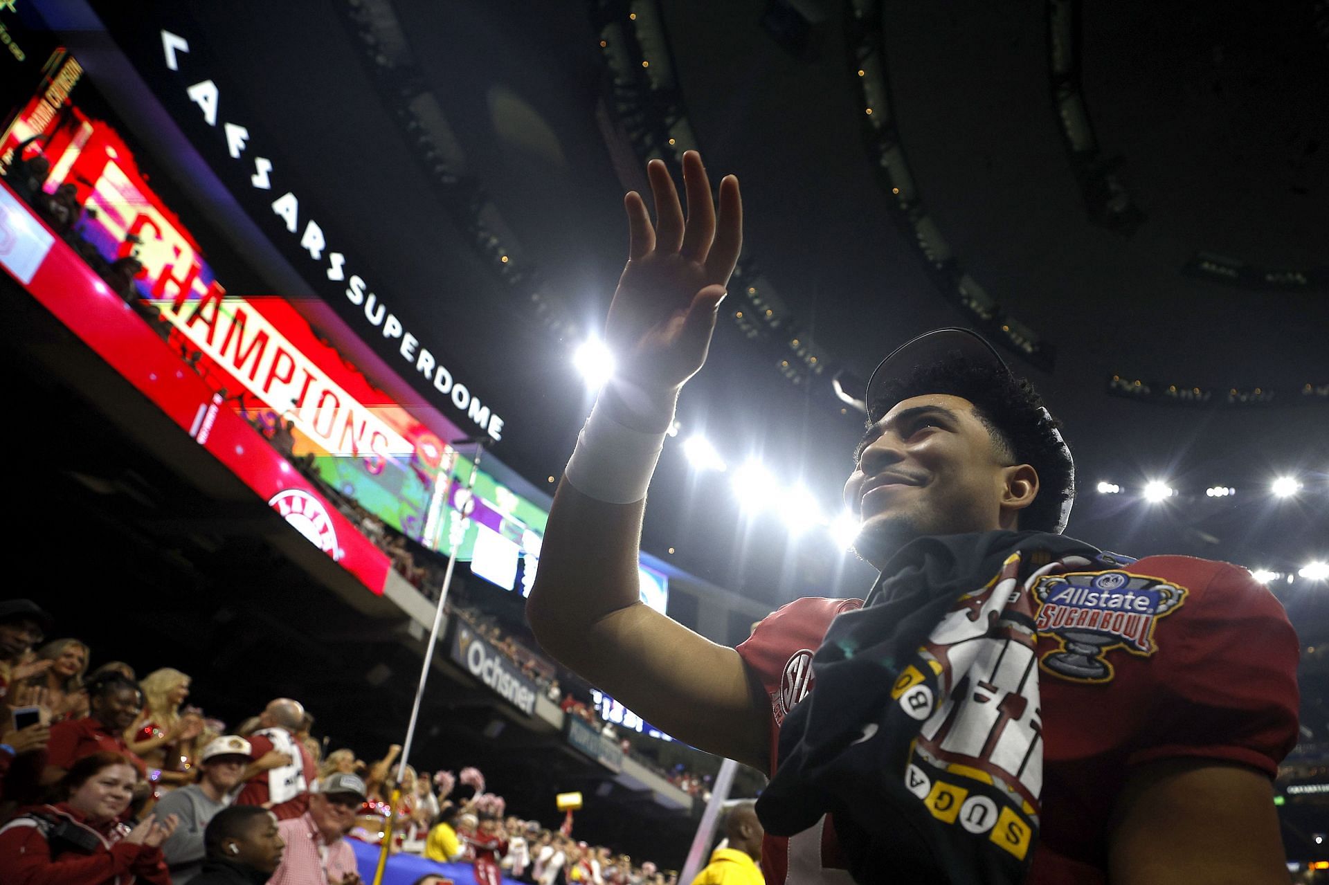 Bryce Young of the Alabama Crimson Tide runs offside the field after receiving the MVP award during the Allstate Sugar Bowl against the Kansas State