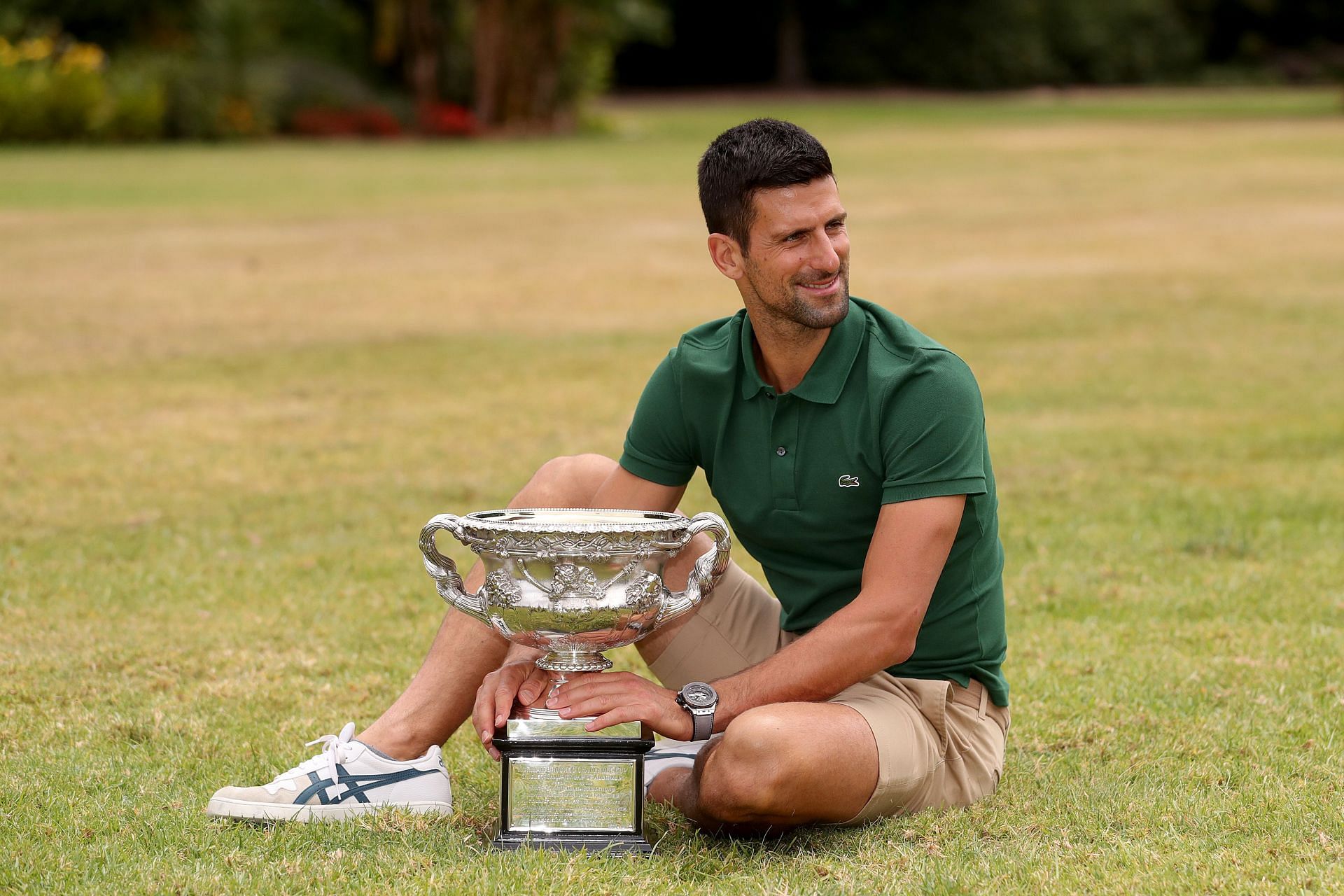 Novak Djokovic posing with the Australian Open trophy