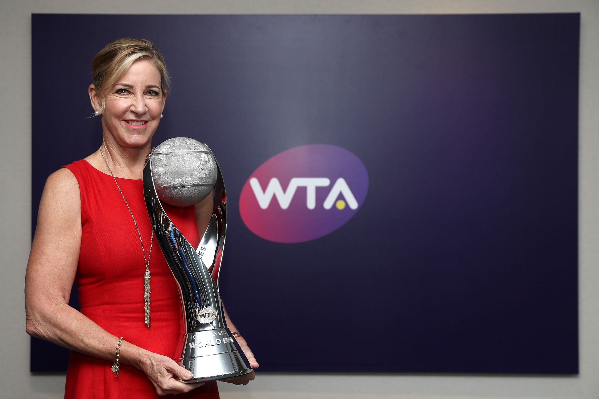 Chris Evert poses with the WTA World Number One singles trophy named in her honor