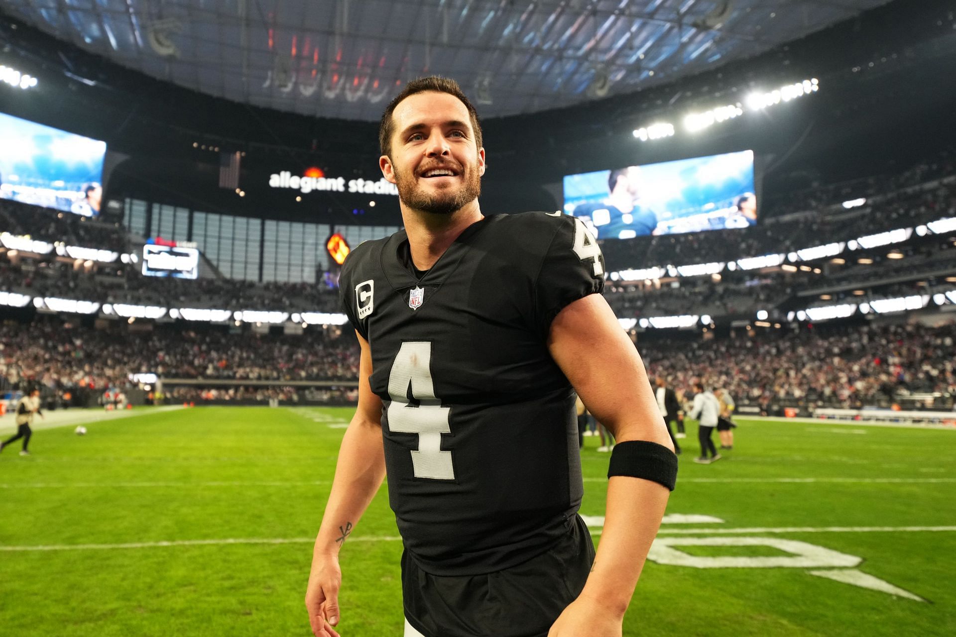 Derek Carr of the Las Vegas Raiders celebrates on the field after defeating the New England Patriots