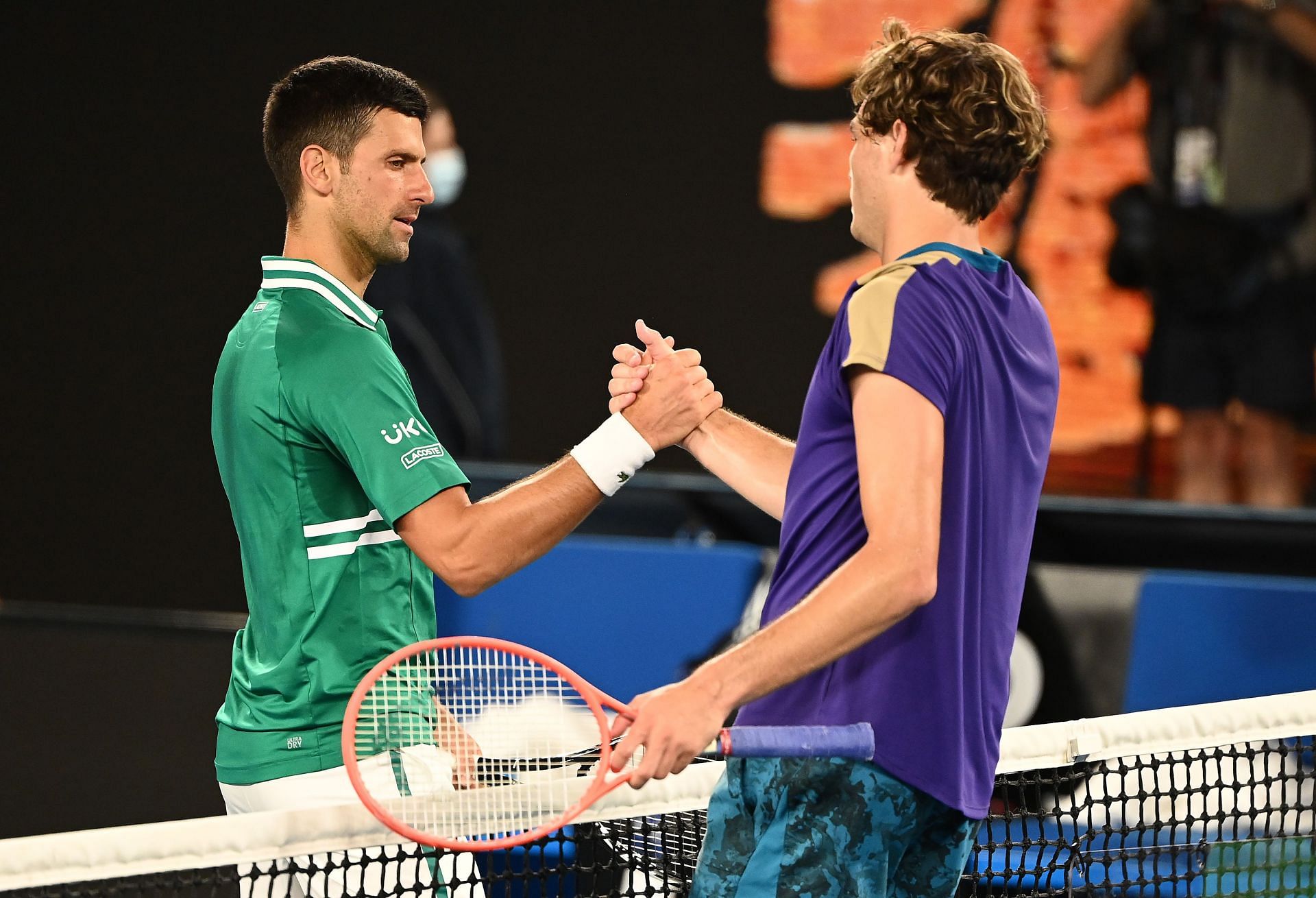 Taylor Fritz greets Novak Djokovic after their 2021 Australian Open match.