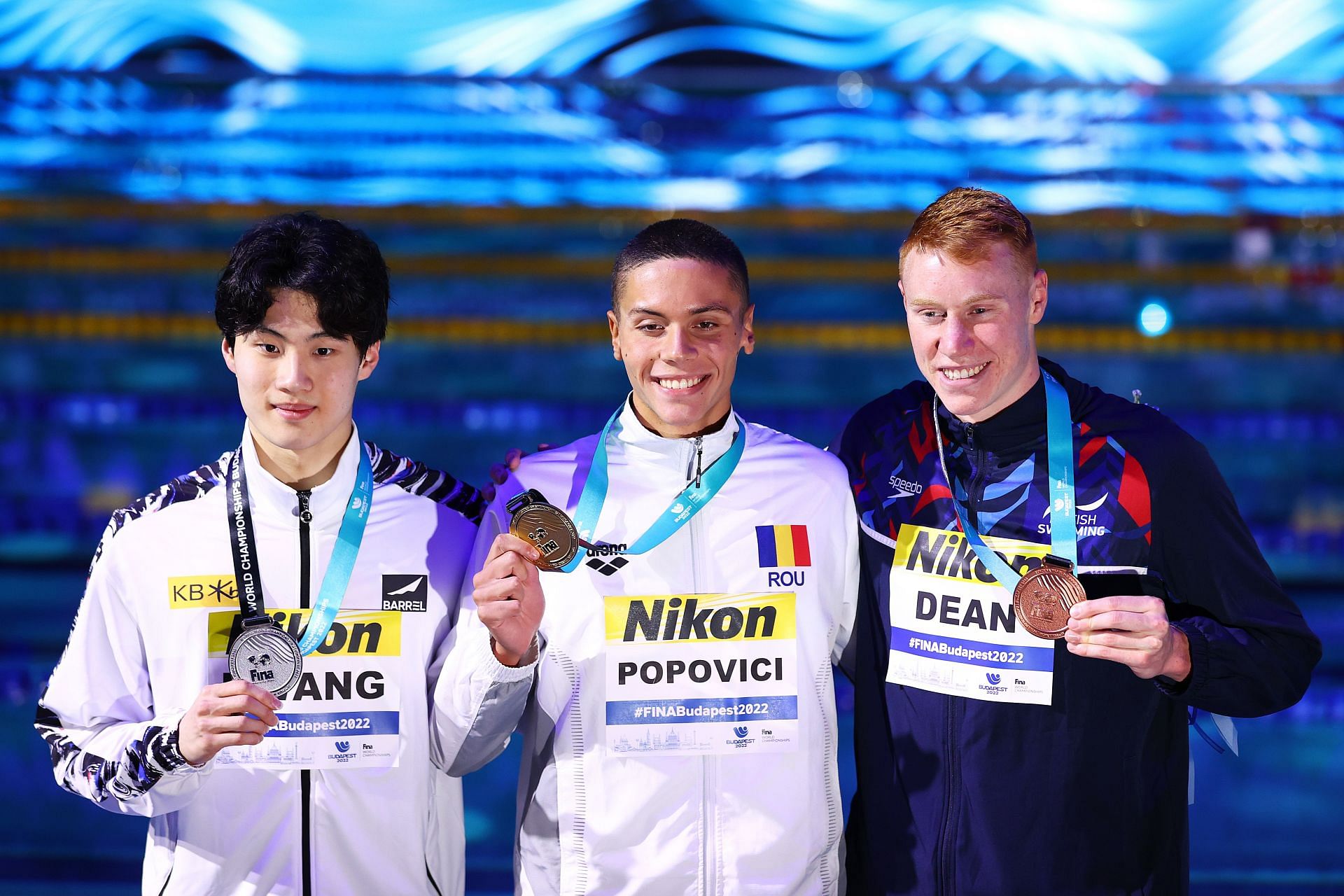 (L-R) Silver medalist Sunwoo Hwang of Team South Korea, Gold medalist David Popovici of Team Romania, and Bronze medalist Tom Dean of Team Great Britain pose with their medals after the Men&#039;s 200m Freestyle Final of the 2022 FINA World Championships in Budapest