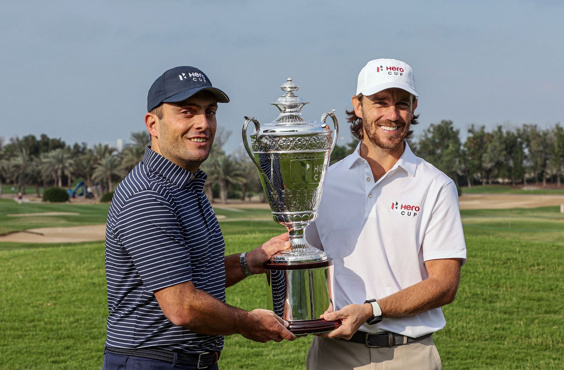 Molinari and Fleetwood posing with the Hero Cup trophy