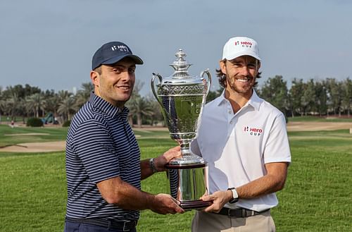 Molinari and Fleetwood posing with the Hero Cup trophy