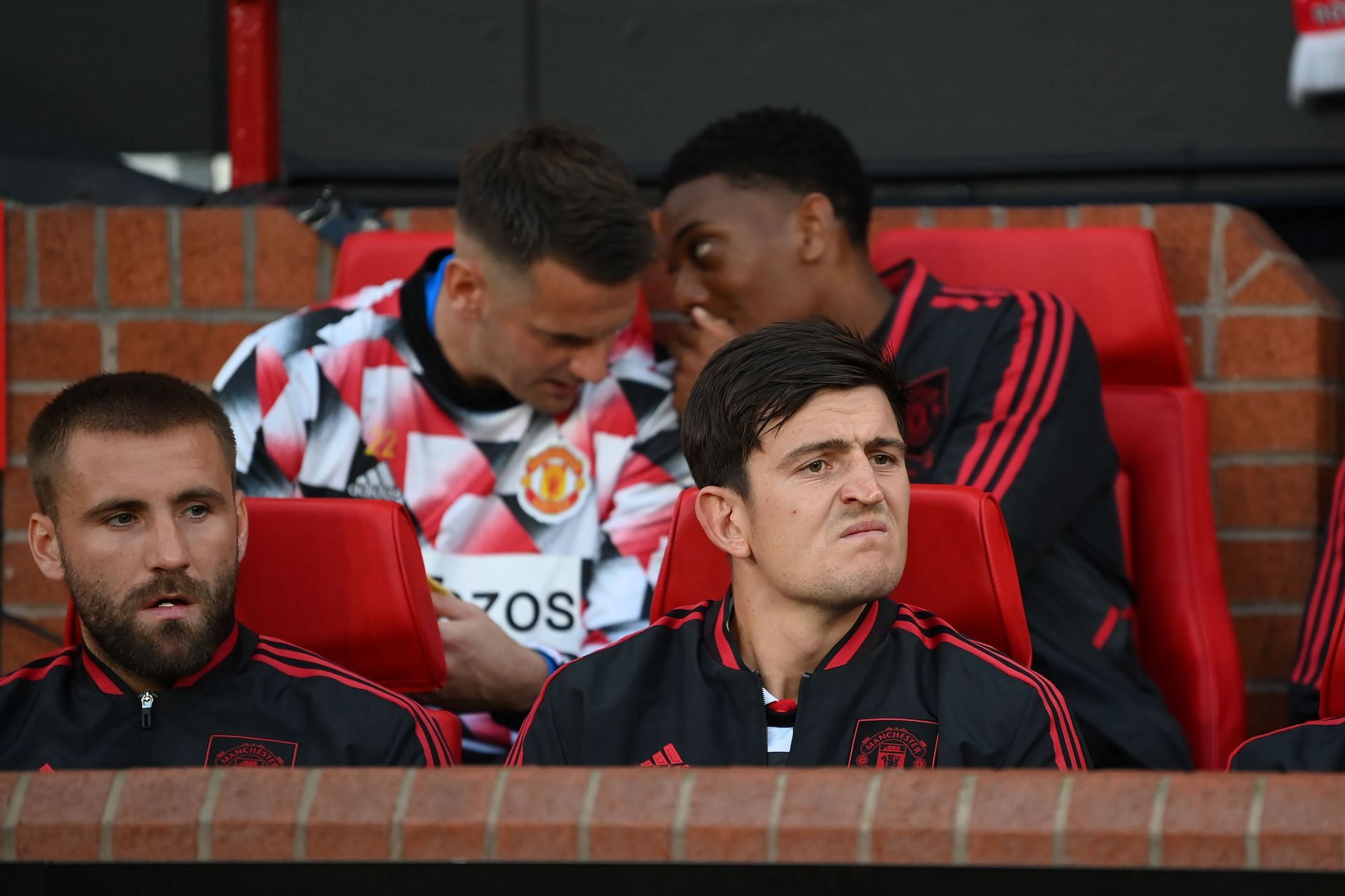 Harry Maguire (right) has had to get used to the substitutes bench.