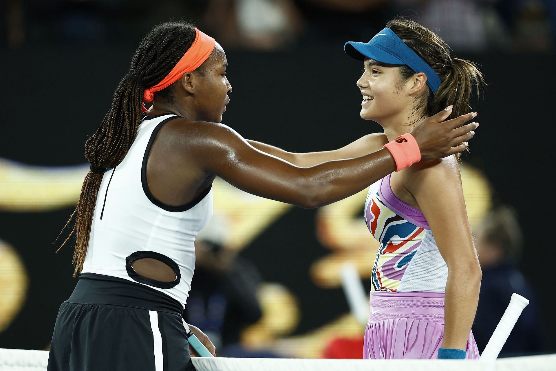 Coco Gauff [L] greets Emma Raducanu at the net after beating her at the 2023 Australian Open