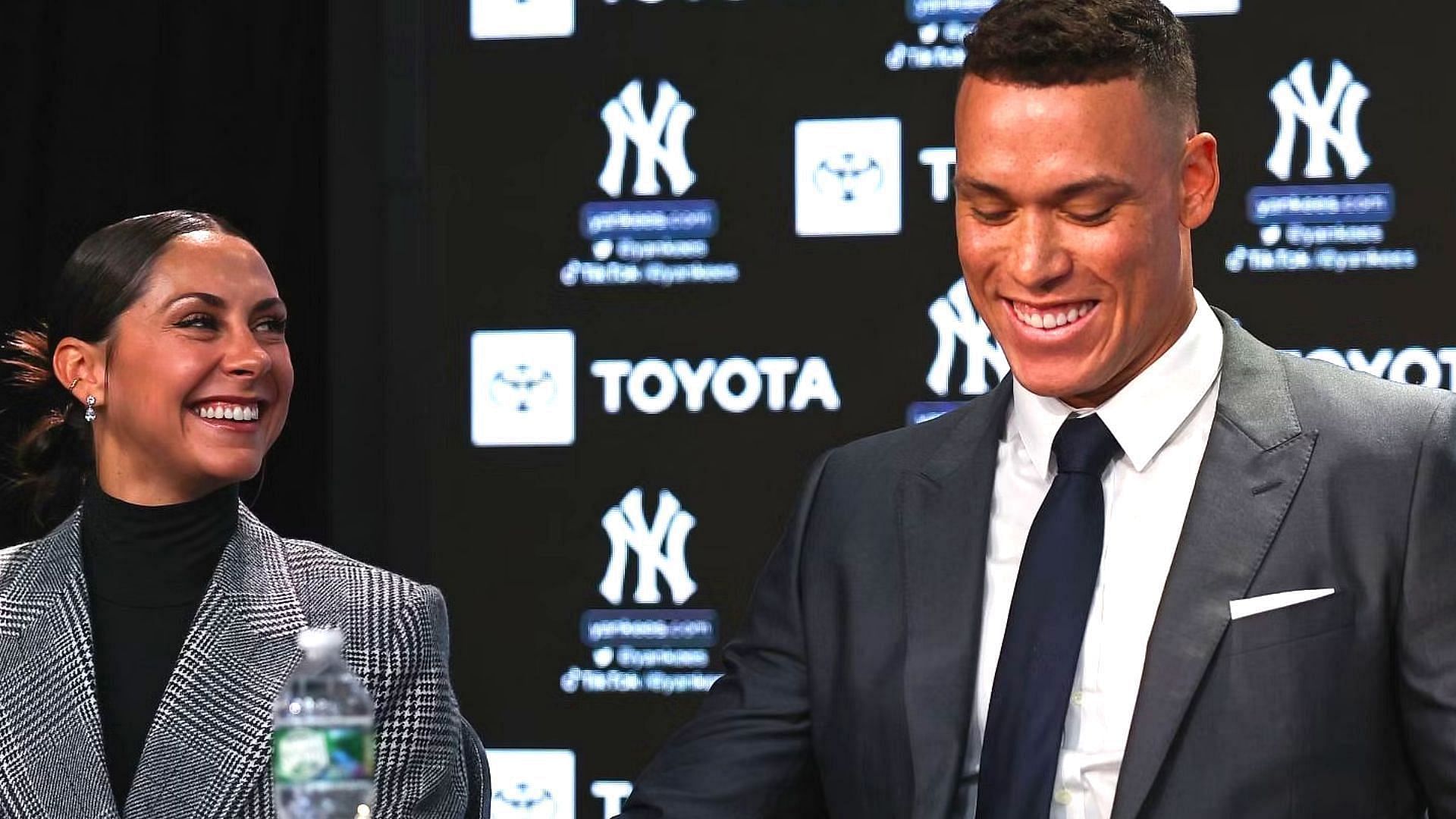 BRONX, NEW YORK - DECEMBER 21: Aaron Judge #99 of the New York Yankees and his wife Samantha Judge look on during a press conference at Yankee Stadium on December 21, 2022 in Bronx, New York. (Photo by Dustin Satloff/Getty Images)