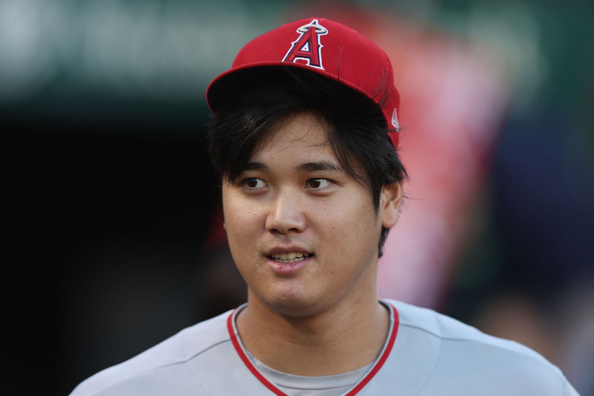 Shohei Ohtani prepares in the dugout before the game against the Oakland Athletics