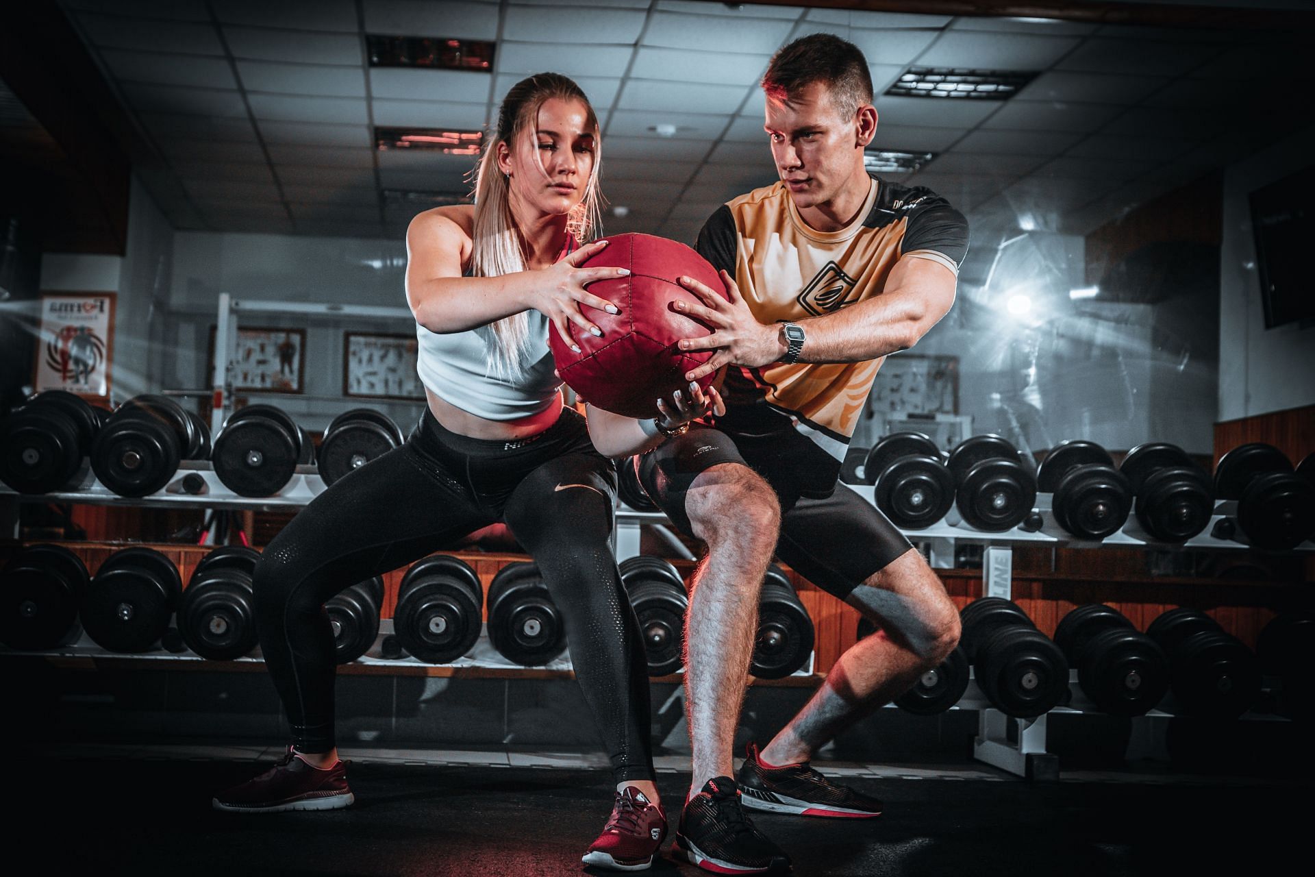 You can do medicine ball squats with a heavy ball, but you can also use a lighter weight. (Image via Pexels/ Andrej Klintsy)