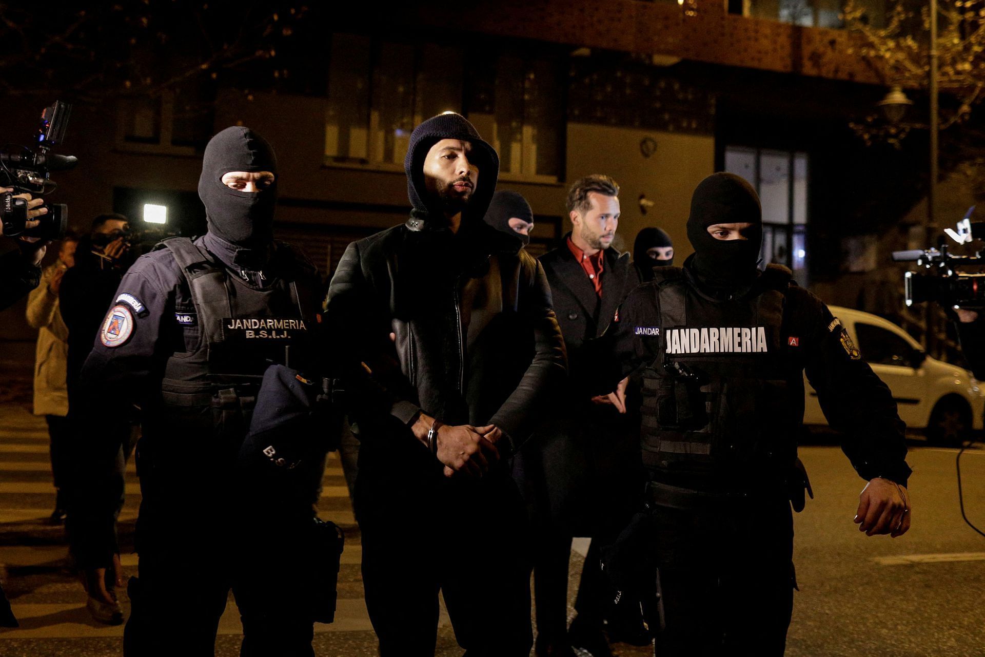 Andrew and Tristan Tate escorted by police officers in Romania (Image via Octav Ganea/Reuters)