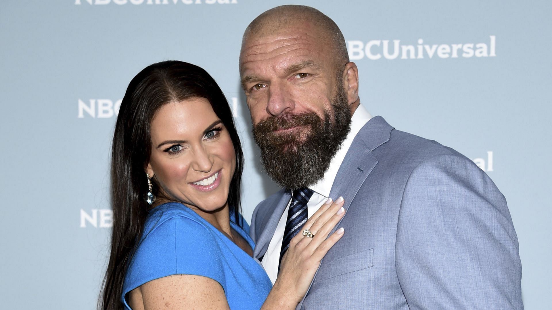 Stephanie McMahon and Triple H posing for a picture.