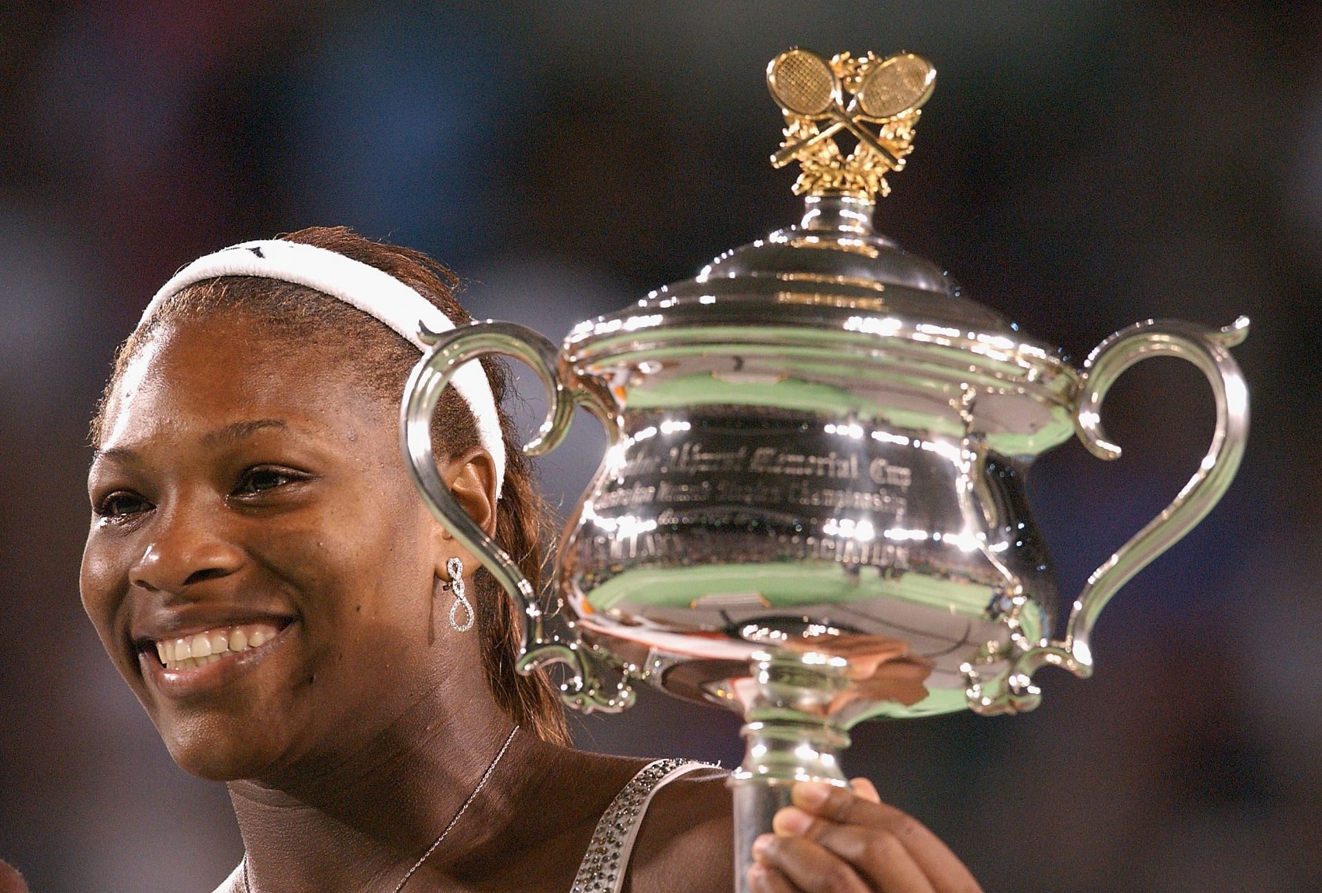 Serena Williams celebrates with the 2003 Australian Open trophy.